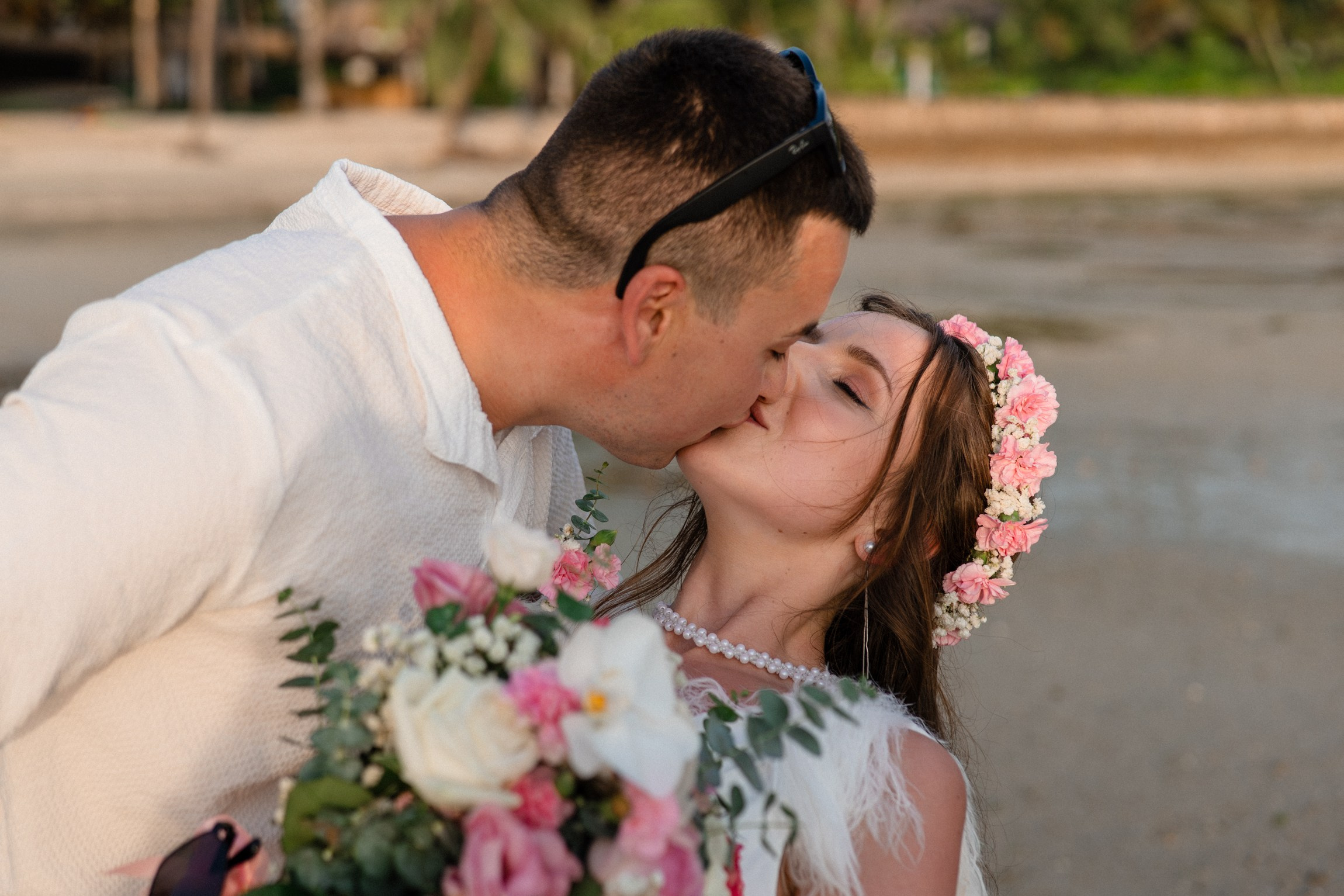 Bride and groom during a romantic beach wedding ceremony on Koh Samui, Thailand, surrounded by tropical scenery and ocean views