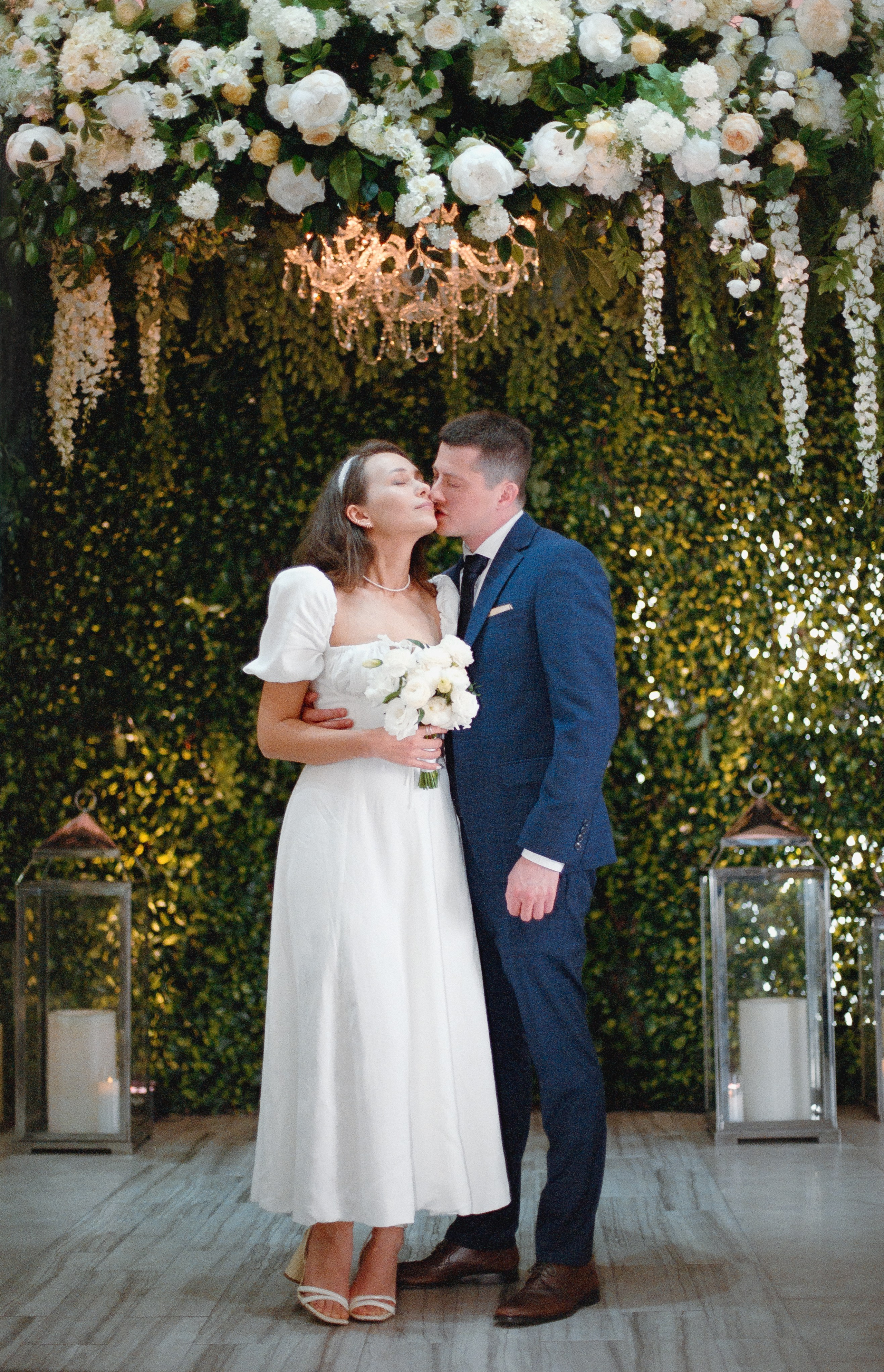 husband kissing his wife for the first time after the wedding ceremony