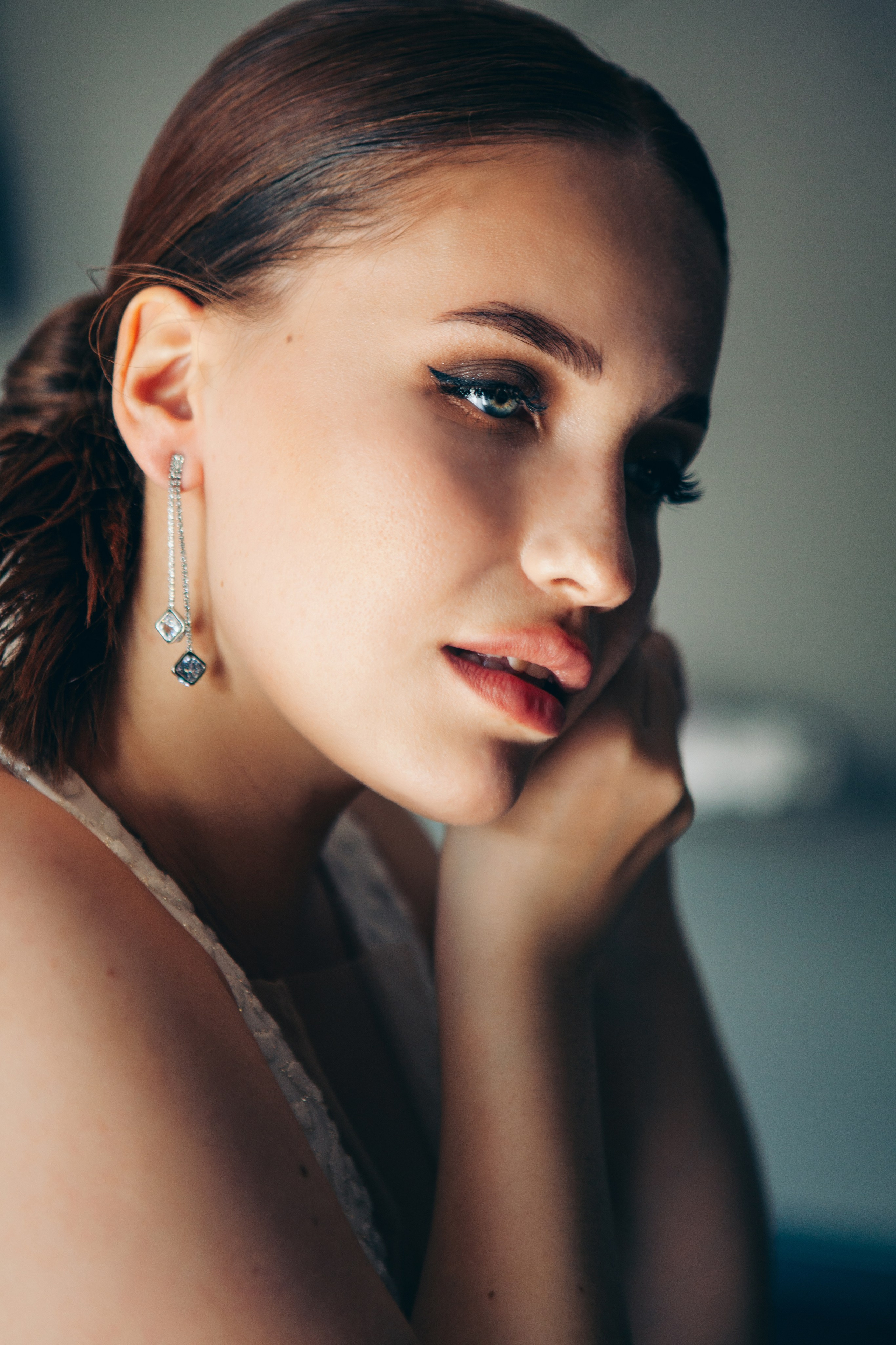 невеста с зелеными глазами и рыжими волосами надевает серьги