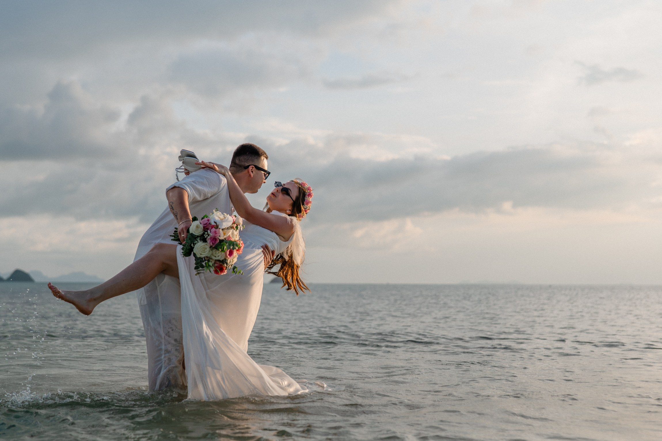 Bride and groom during a romantic beach wedding ceremony on Koh Samui, Thailand, surrounded by tropical scenery and ocean views