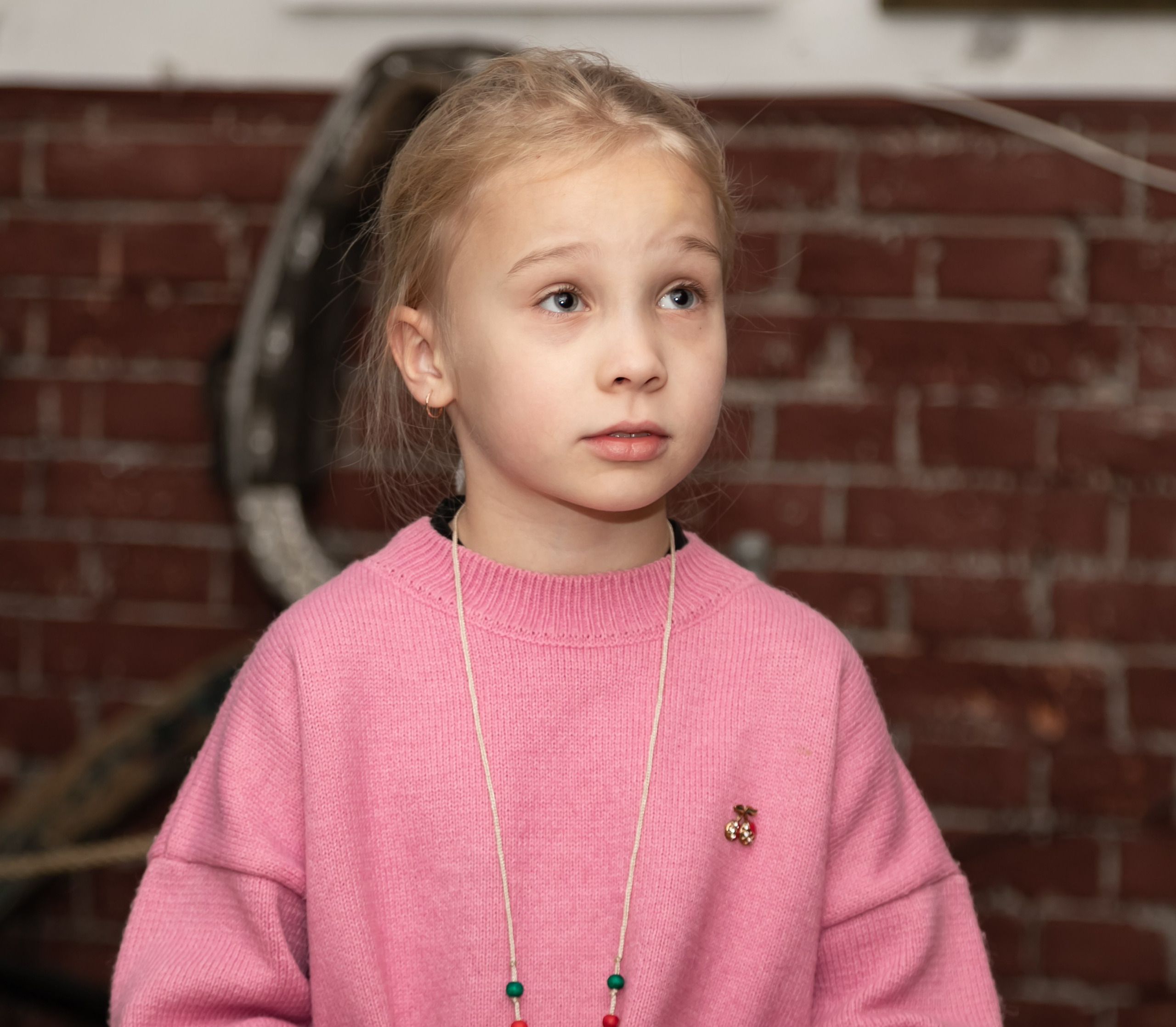 Детская  фотосъемка - девочка в розовом на фоне кирпичной стены