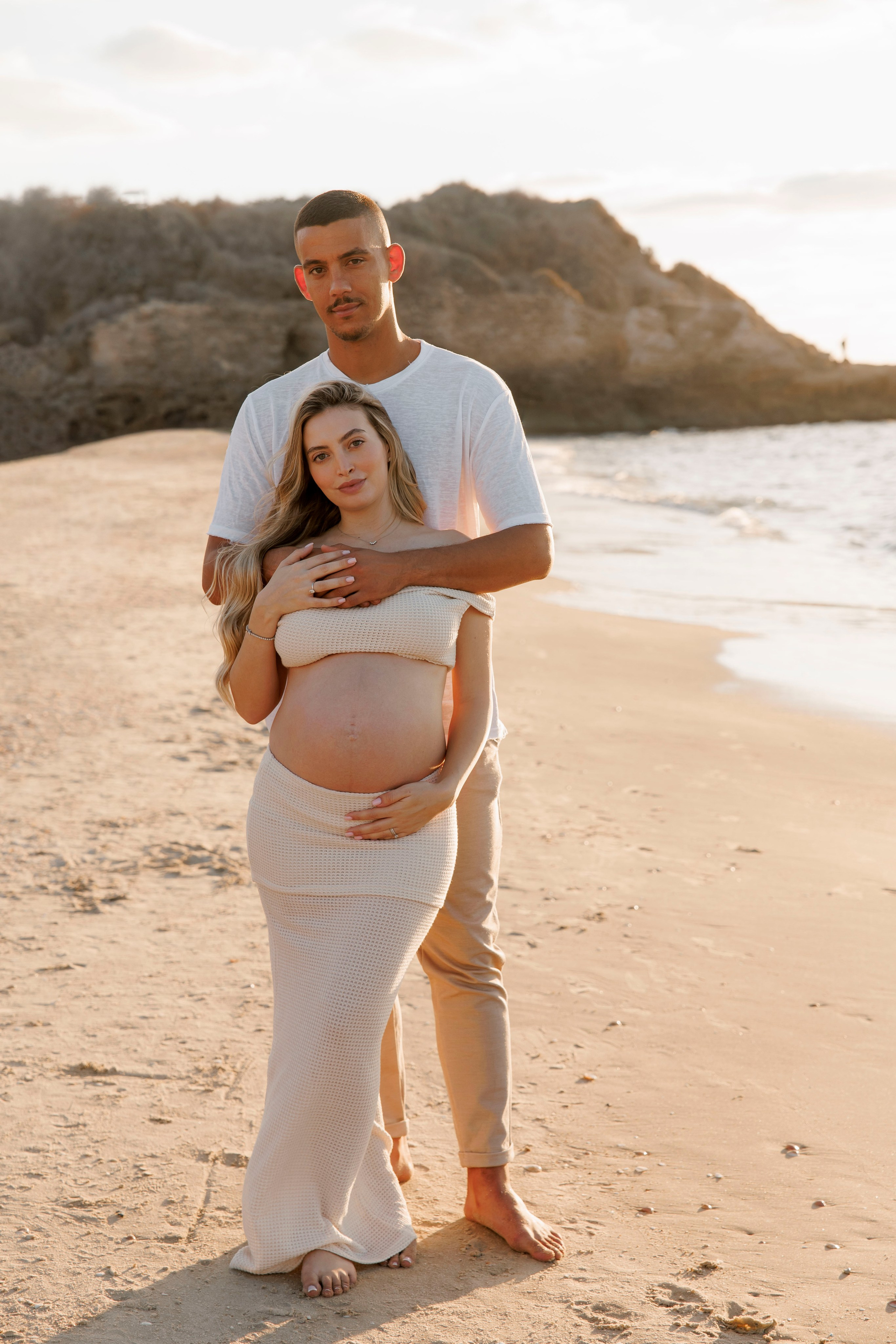 Pregnancy photoshoot near the sea. Wedding and family photographer