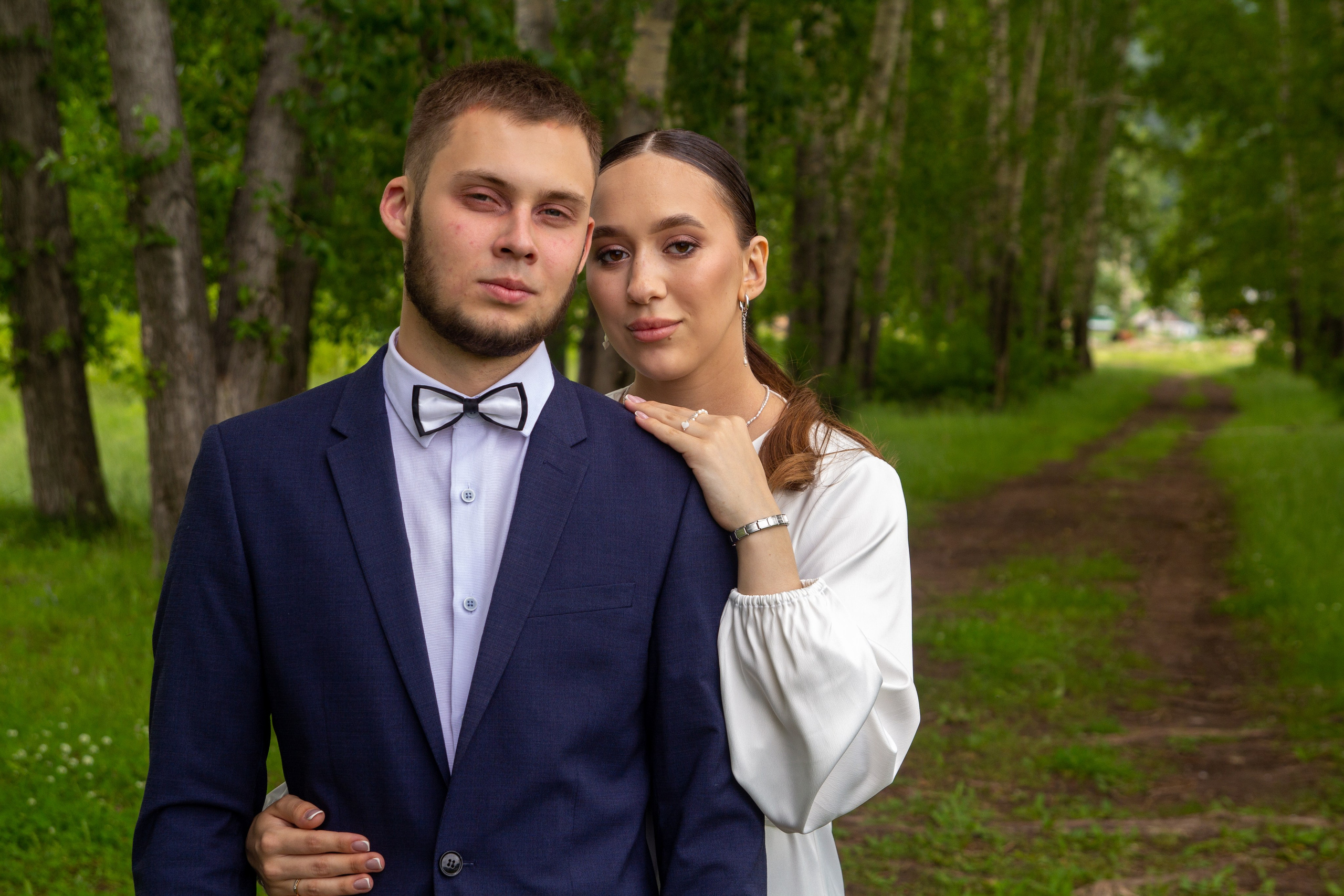 Портрет жениха и невесты на фоне зелёного леса — спокойная и романтичная сцена.