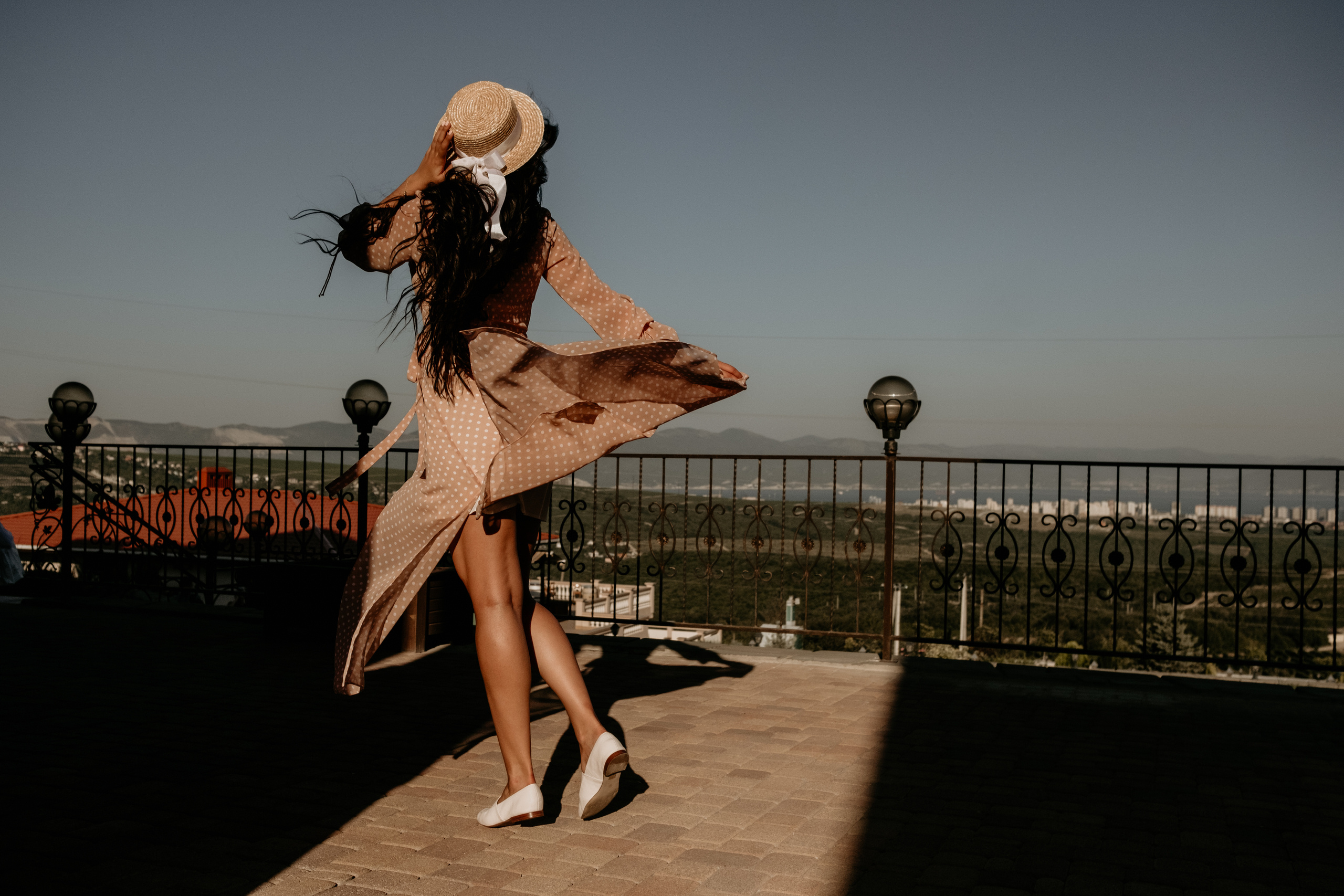 девушка в платье на фоне виноградников в шляпе