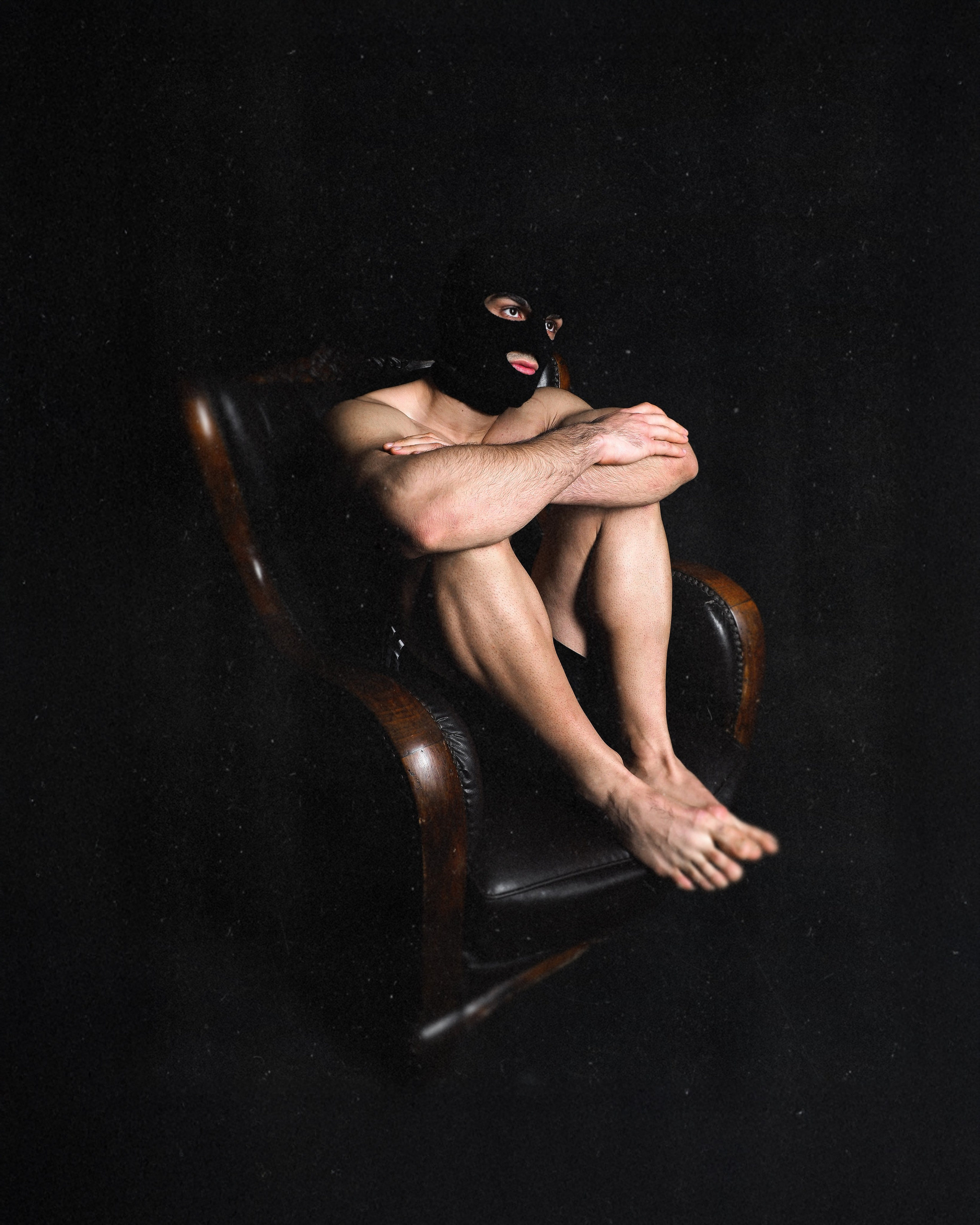 Artistic masked nude male portrait seated in chair, conceptual fine art photography, Sergio Maiis