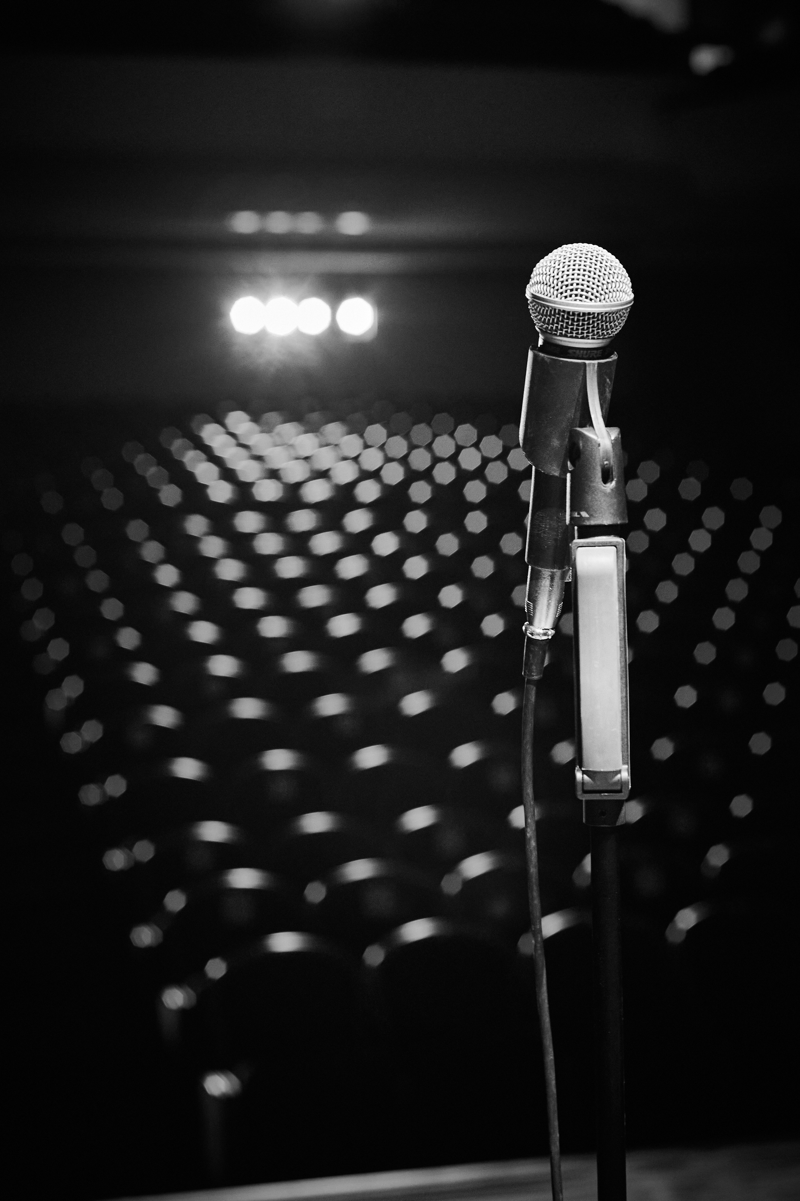 Микрофон для стендапа на фоне зрительного зала