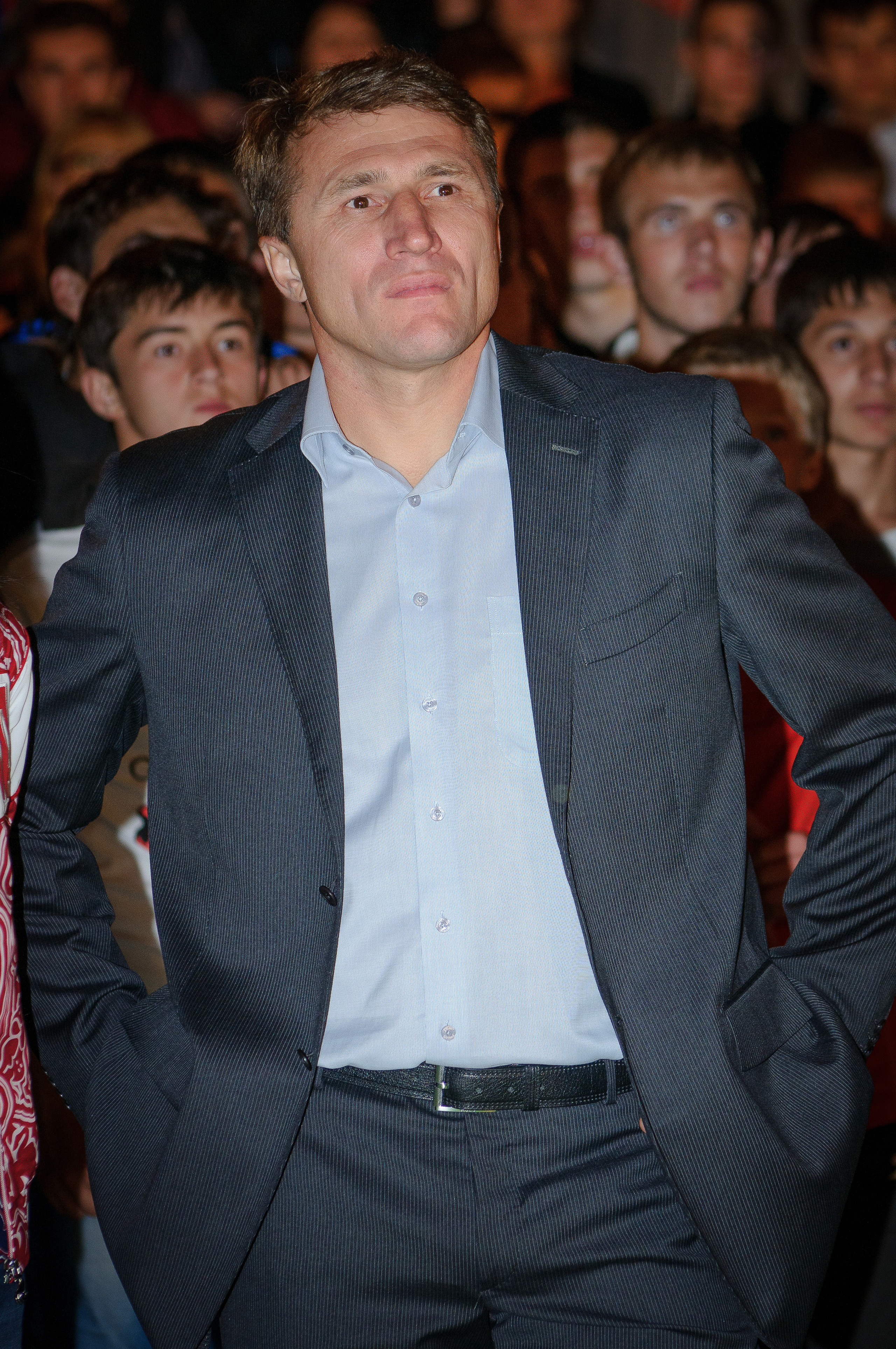 Олег Веретенников в костюме на фоне зрителей