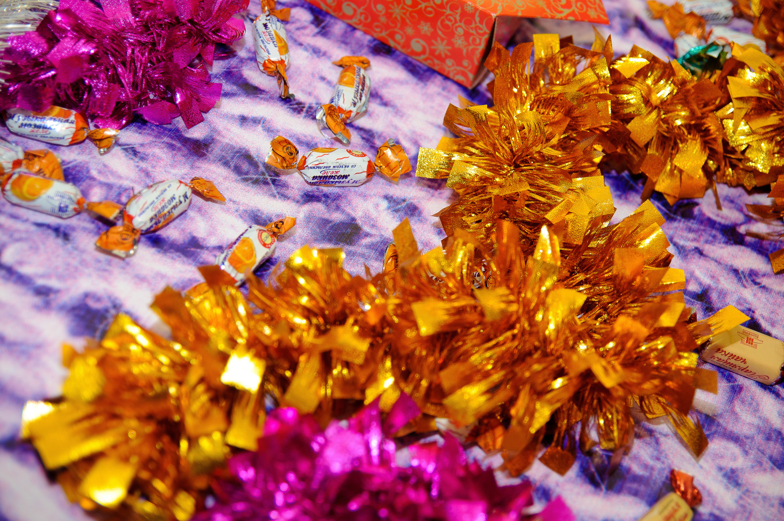 Новогодняя мишура и конфеты лежат на столе