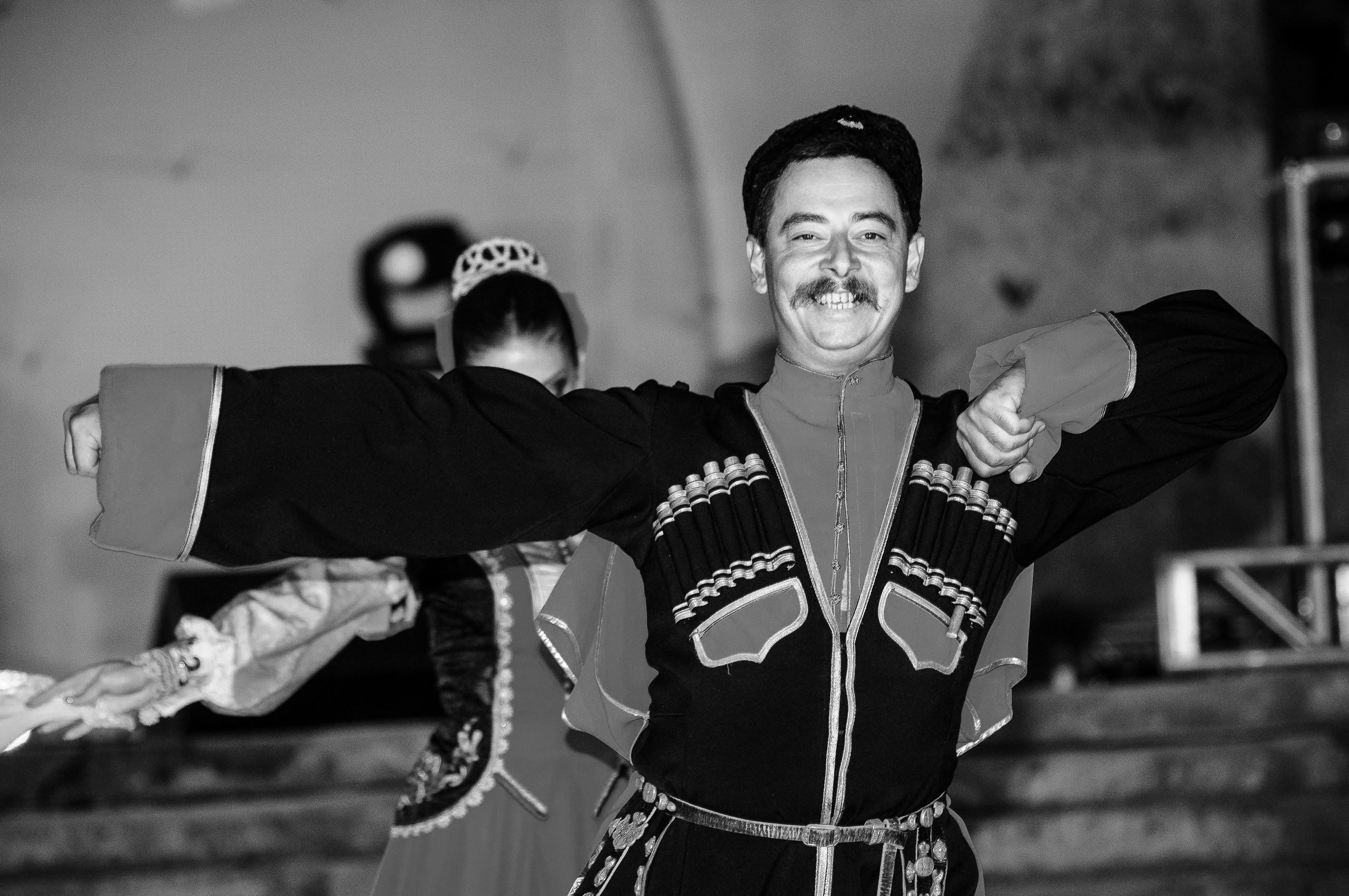 Кавказец в национальном костюме танцует лезгинку