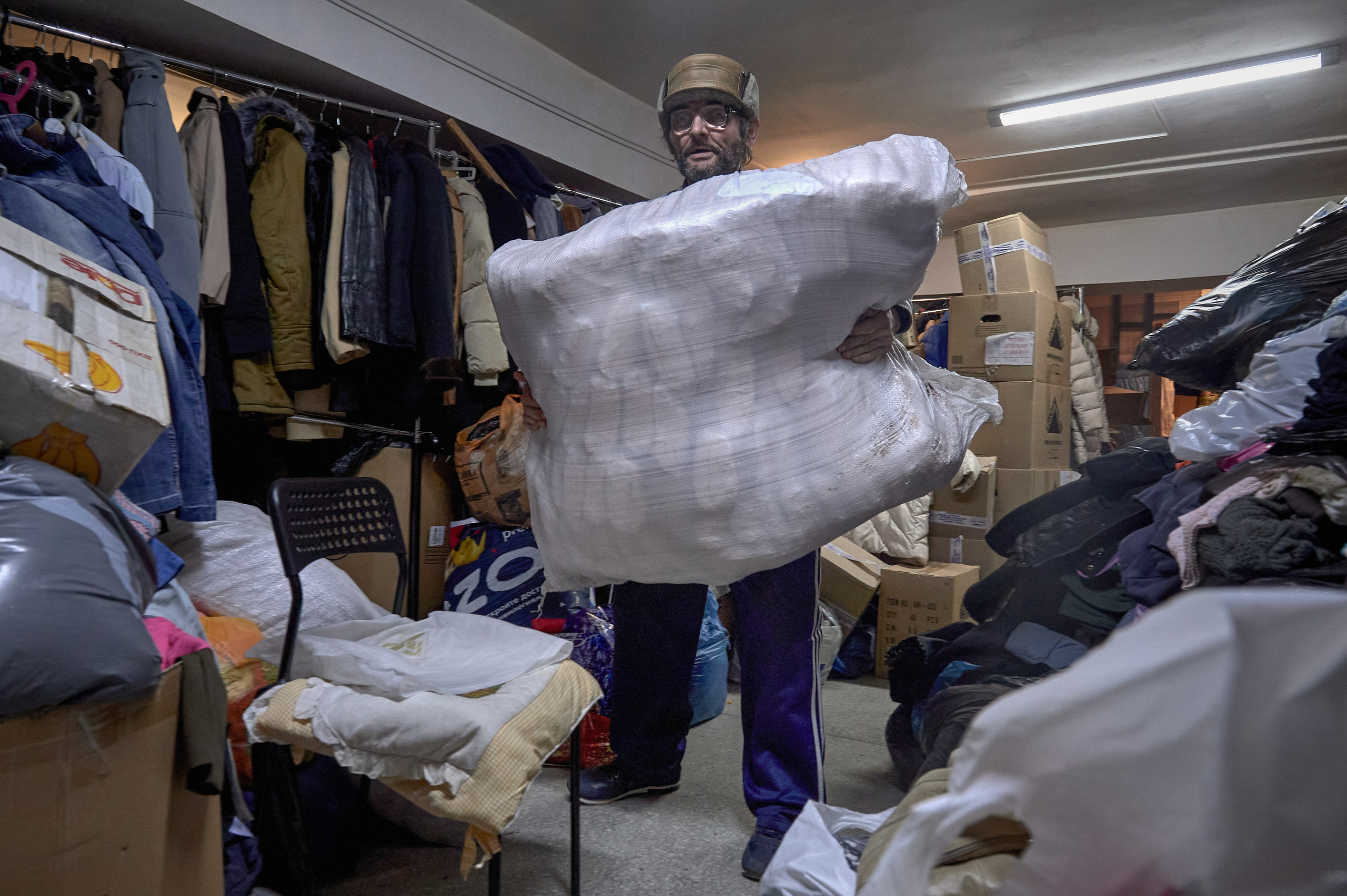 A resident of the "Don Obitel" shelter assists at the humanitarian aid center for refugees located at the Church of the Protection of the Holy Virgin in Rostov-on-Don, February 26, 2022.