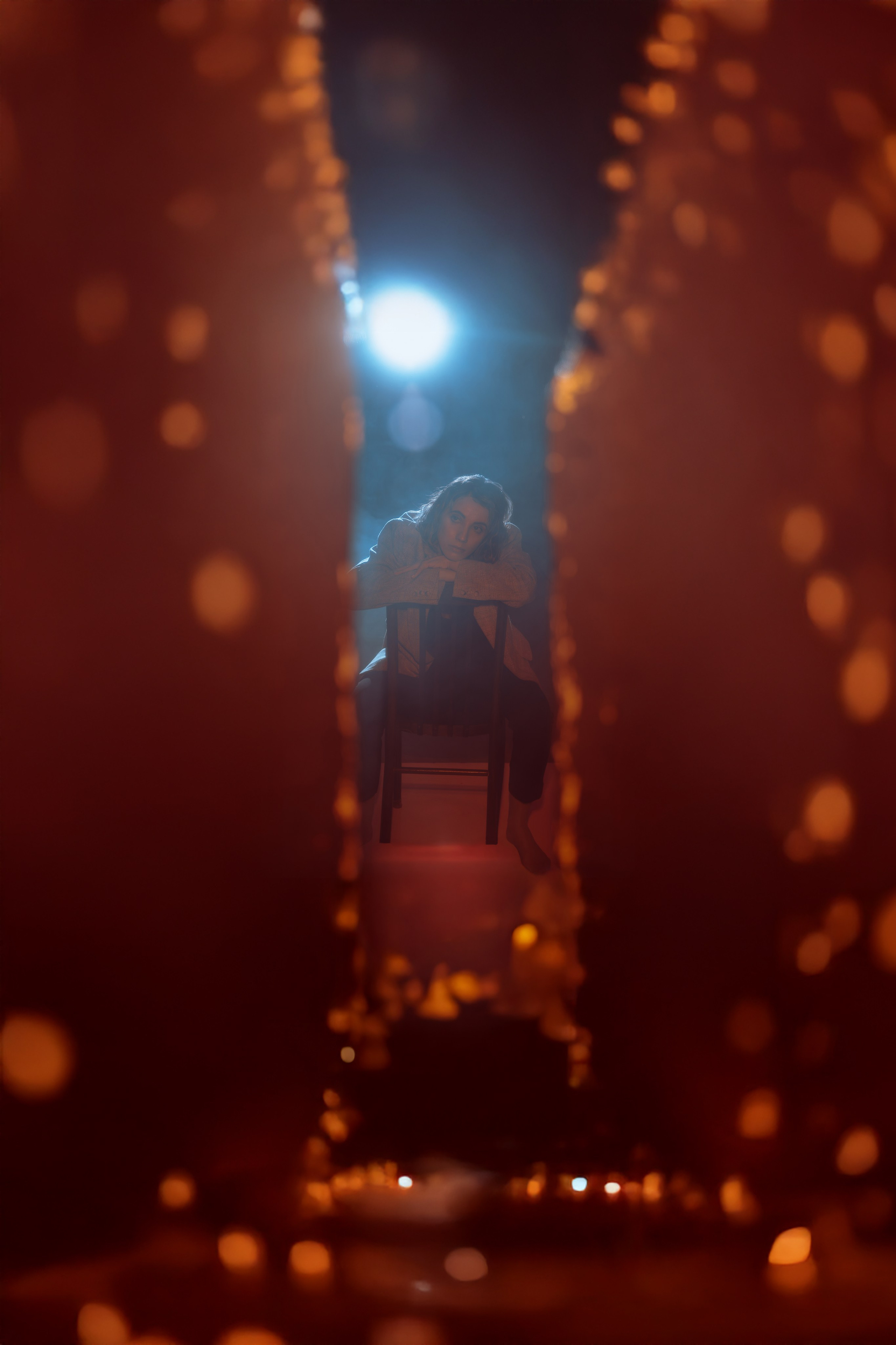 Художник Лана сидит на стуле между фантастическими стенами