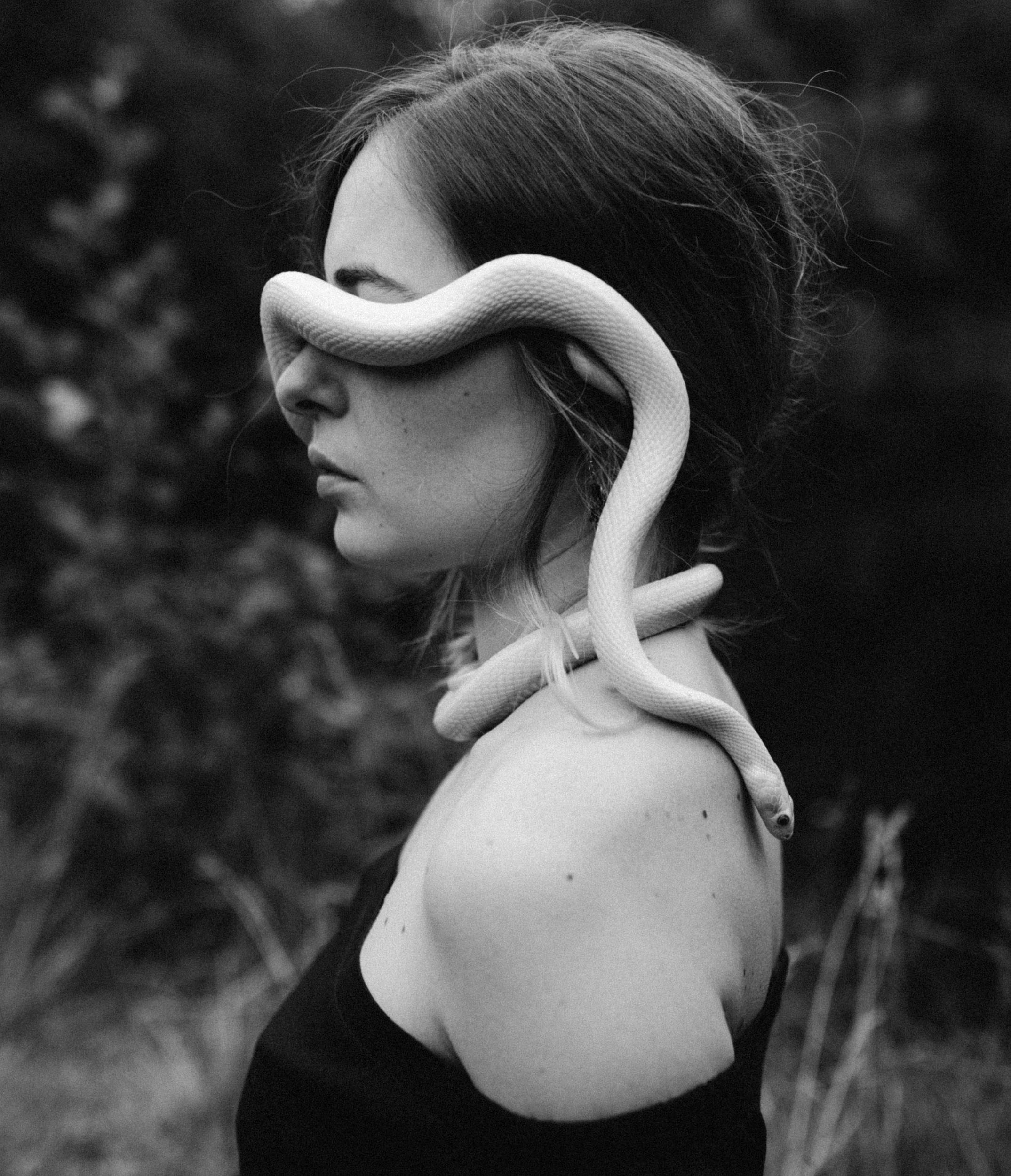 Маленькая белая змея на лице девушки