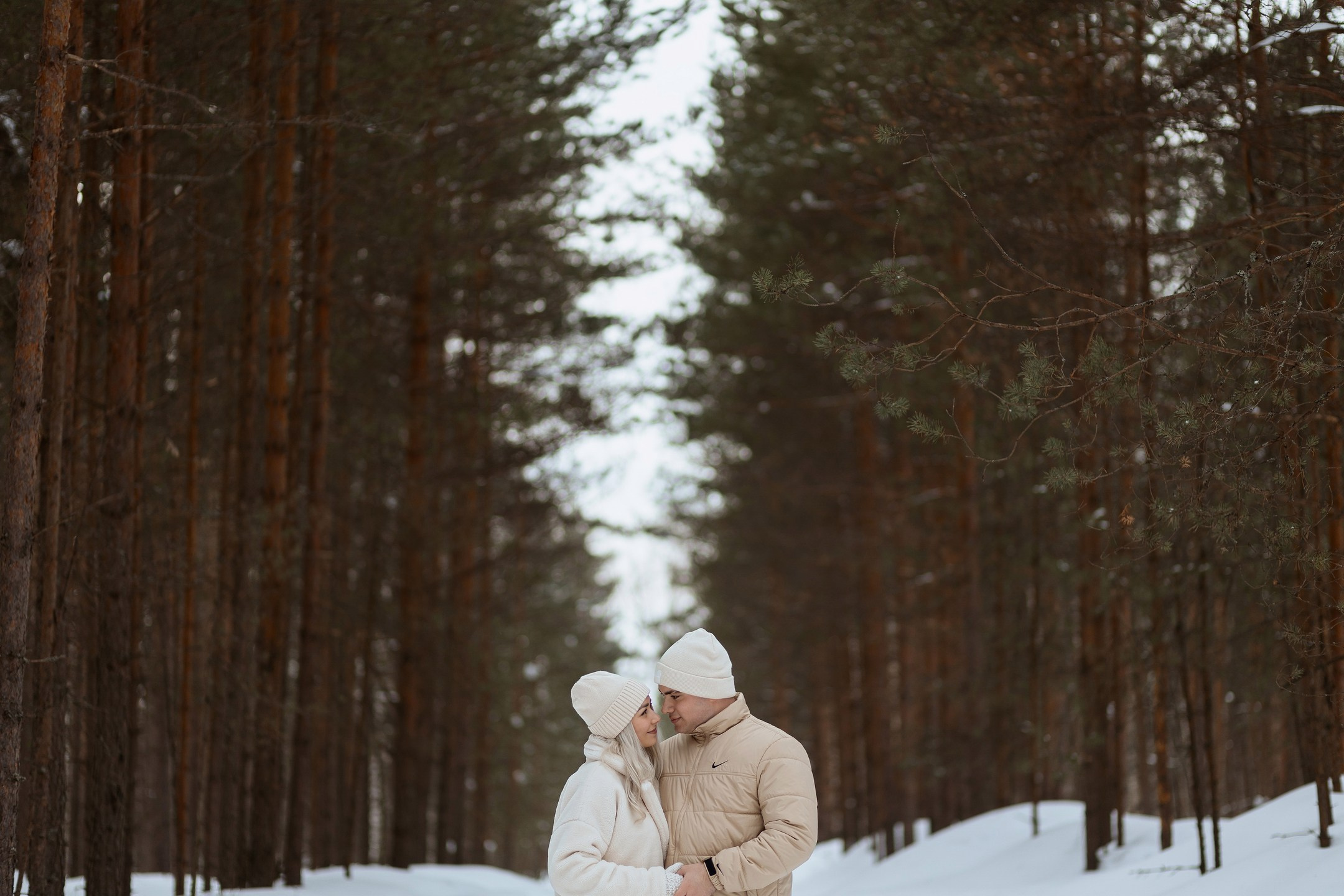  Пара катается на санках в заснеженном парке Москвы  