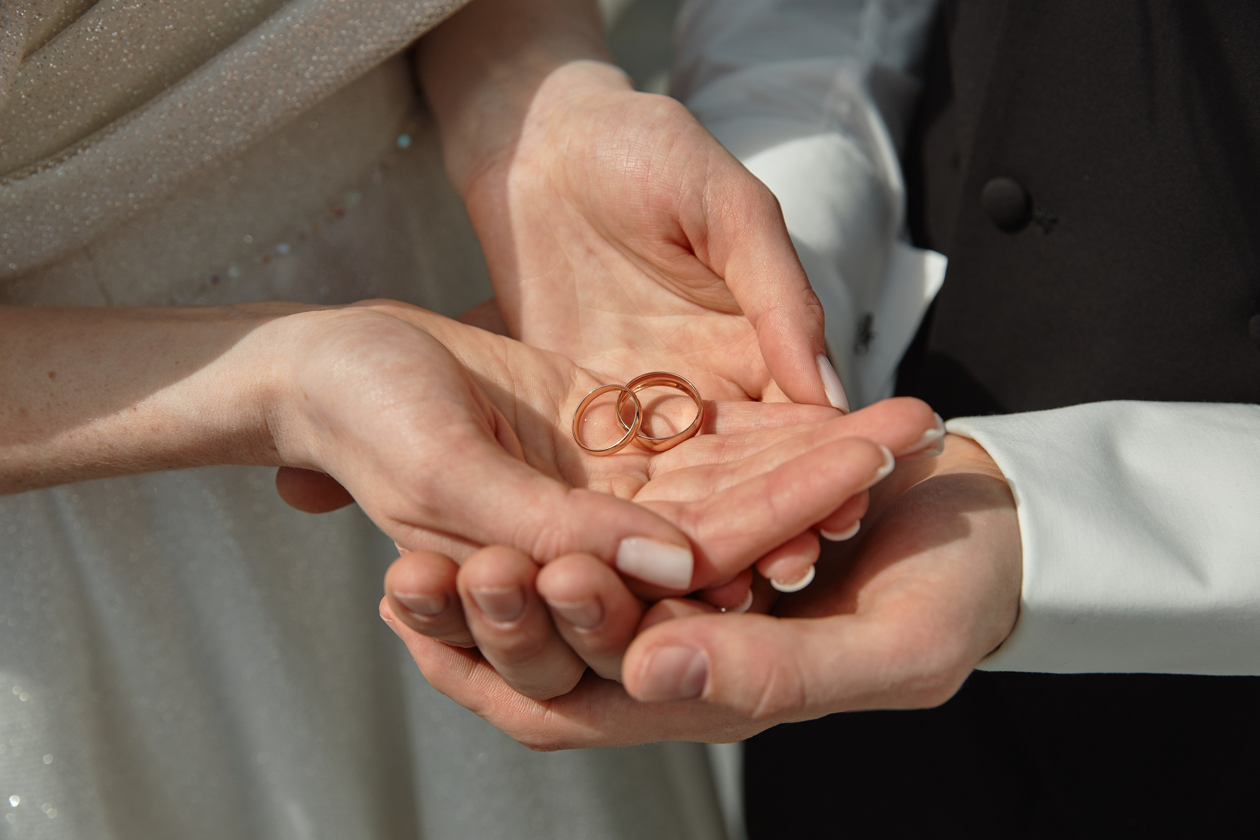 Молодожены держат кольца в руках на набережной Анапы