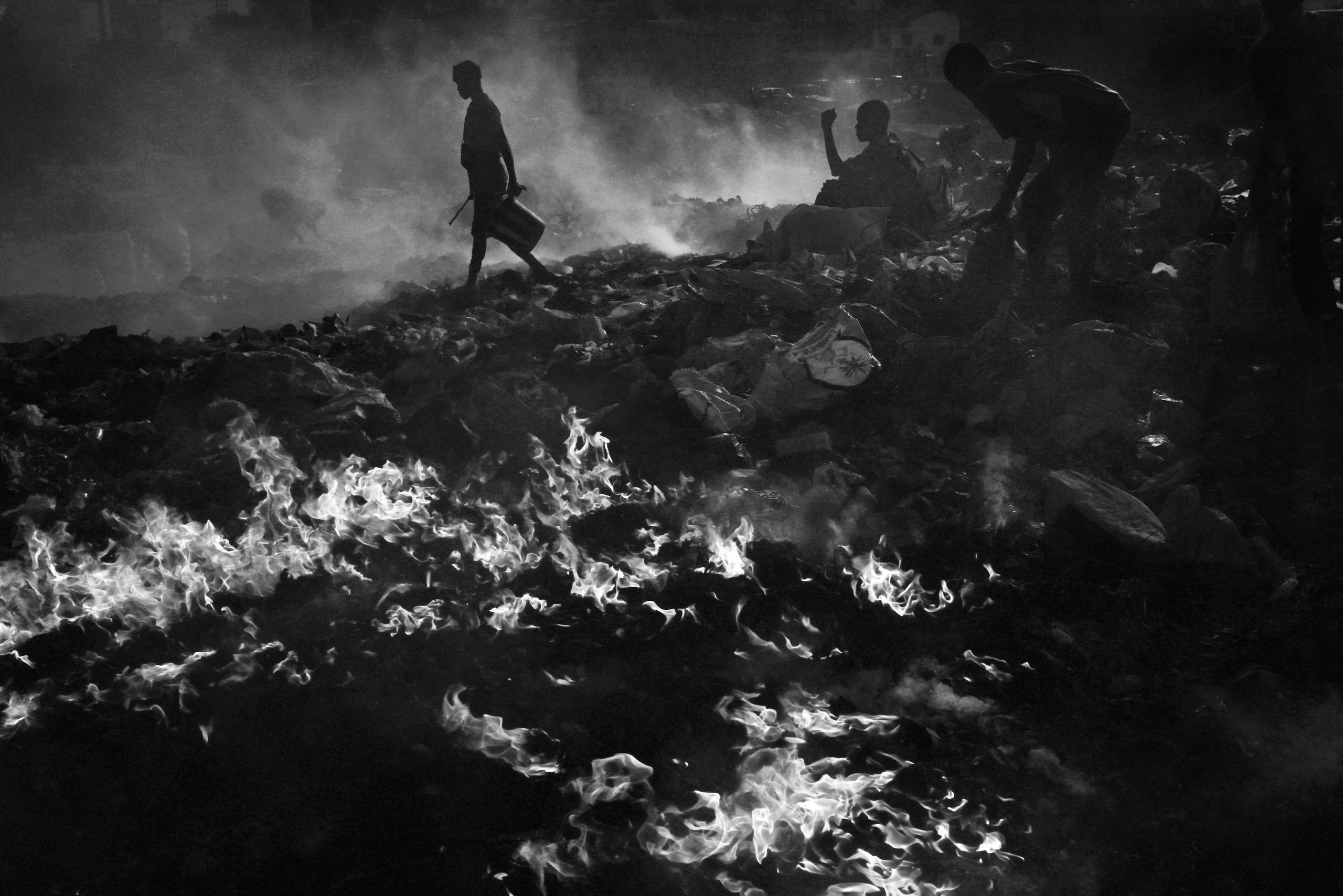 A scavenger walks through the smoke.