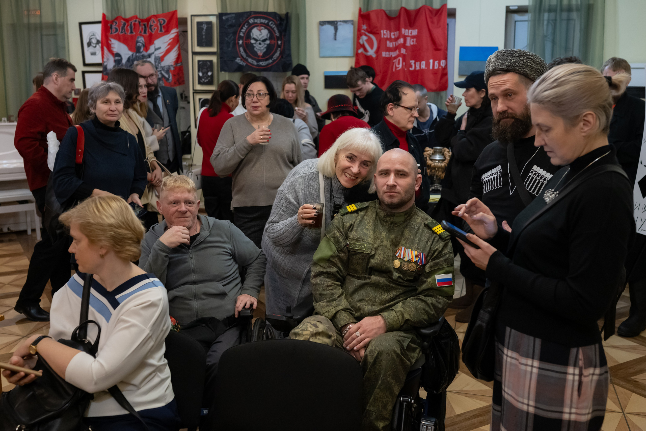People pose, talk, and view exhibits at the opening of the art exhibition "Time Z," dedicated to the special military operation in Ukraine. November 28, 2024.