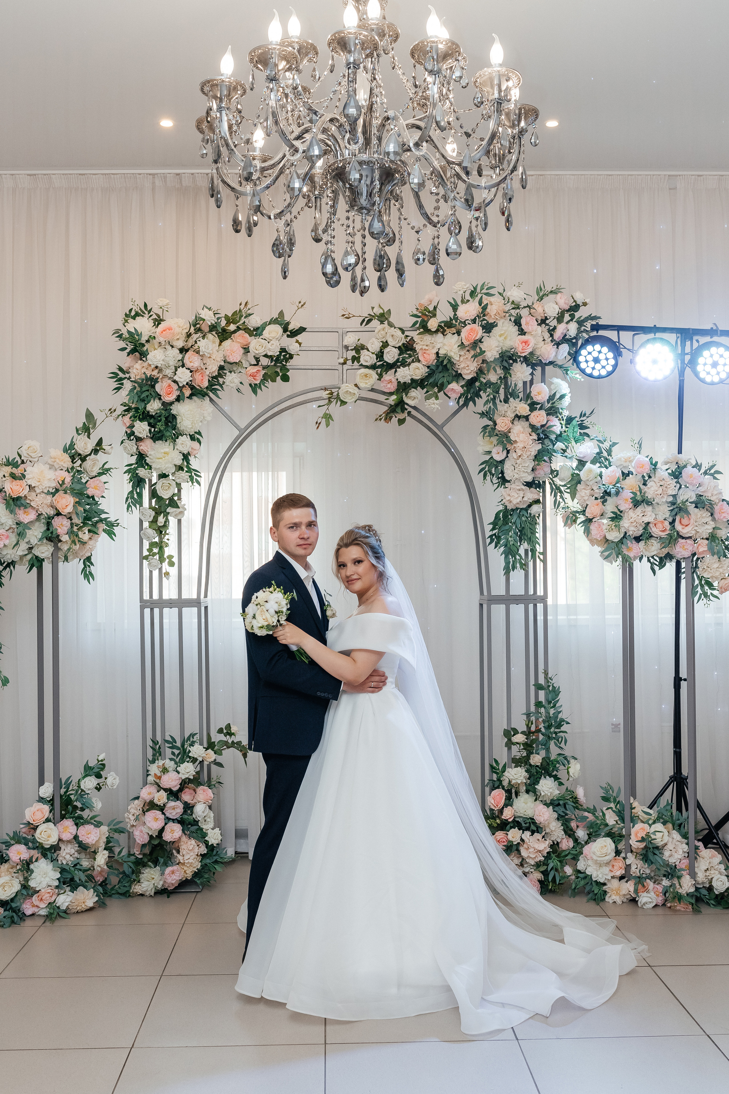 Жених и невеста, портрет, в красивом зале с большой люстрой