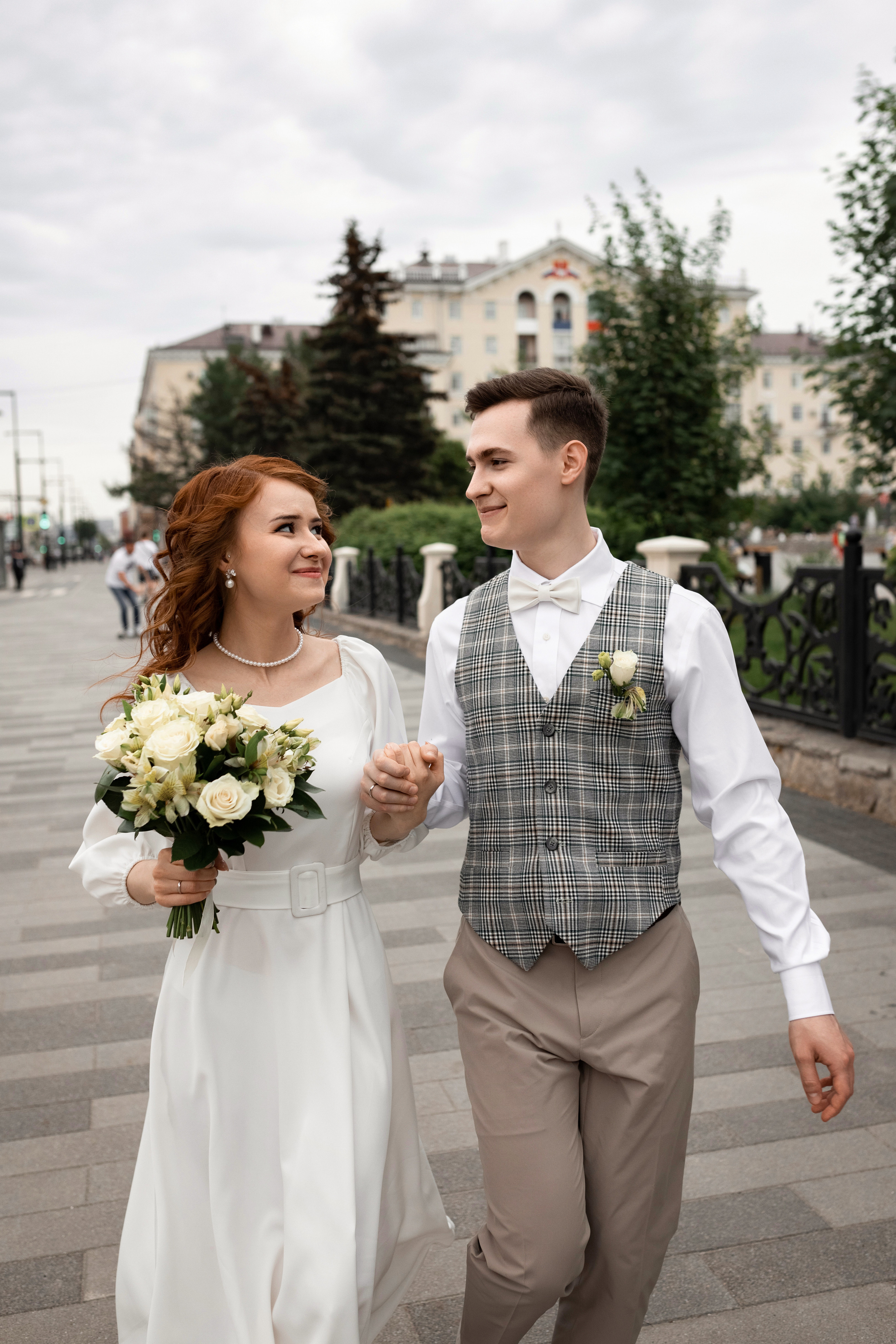 жених и невеста бегут по аллее