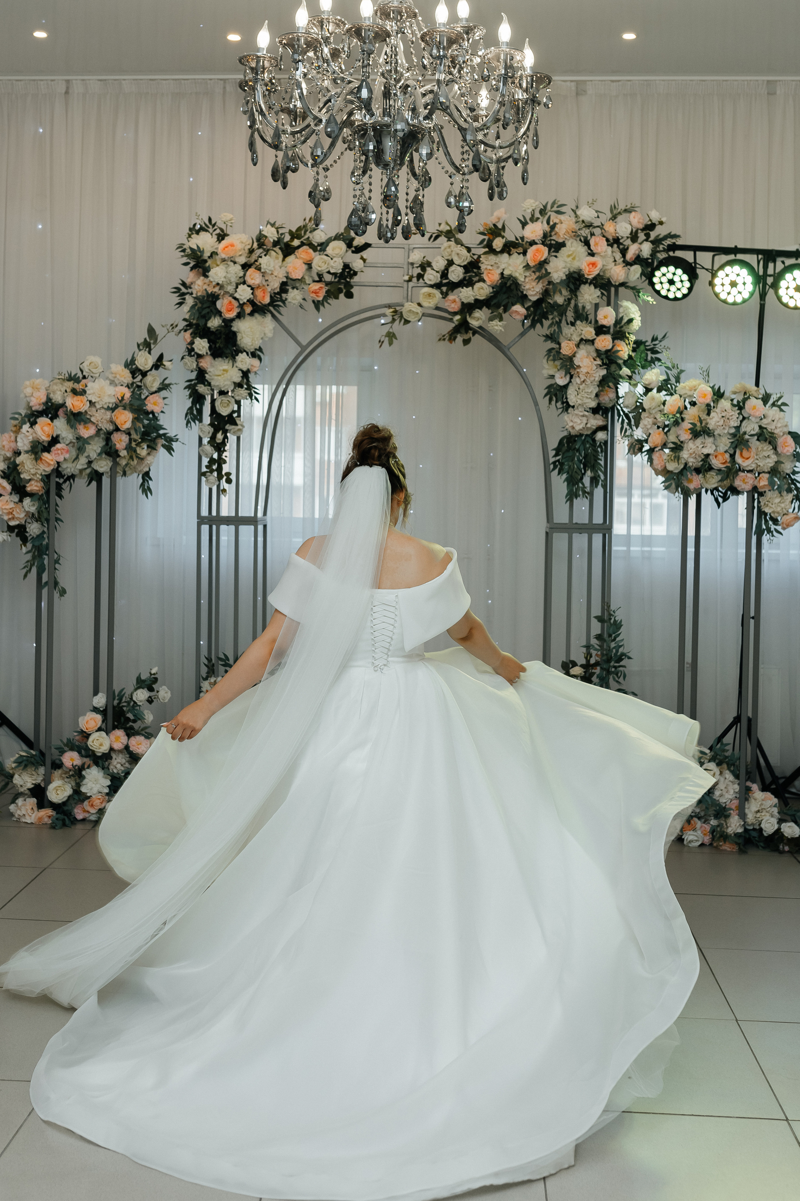 Невеста кружится в белом платье, играет подолом