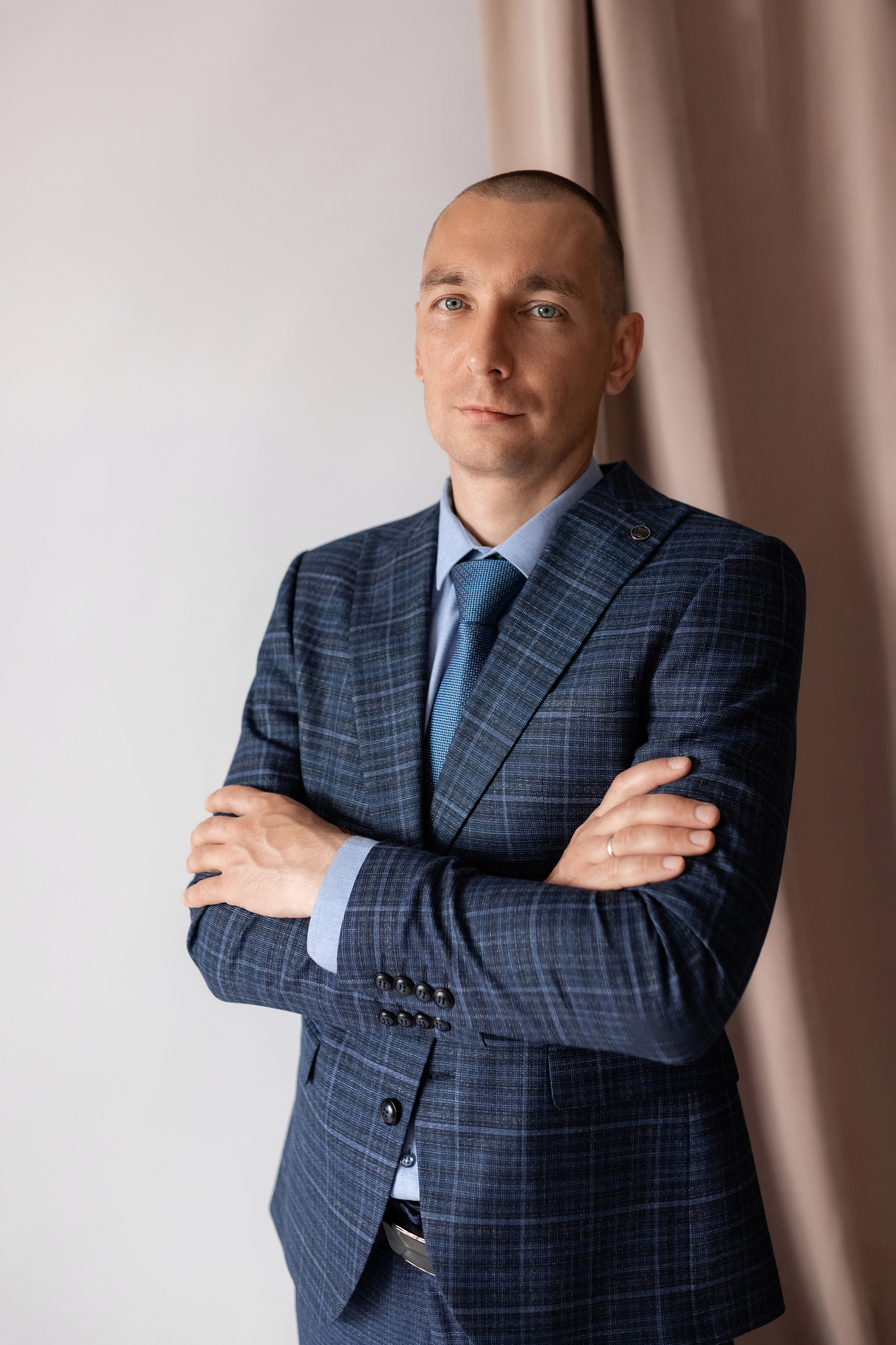 Индивидуальная мужская фотосессия в студии минимализм. на стуле. на белом фоне, на бежевом фоне. В классическом костюме тройка