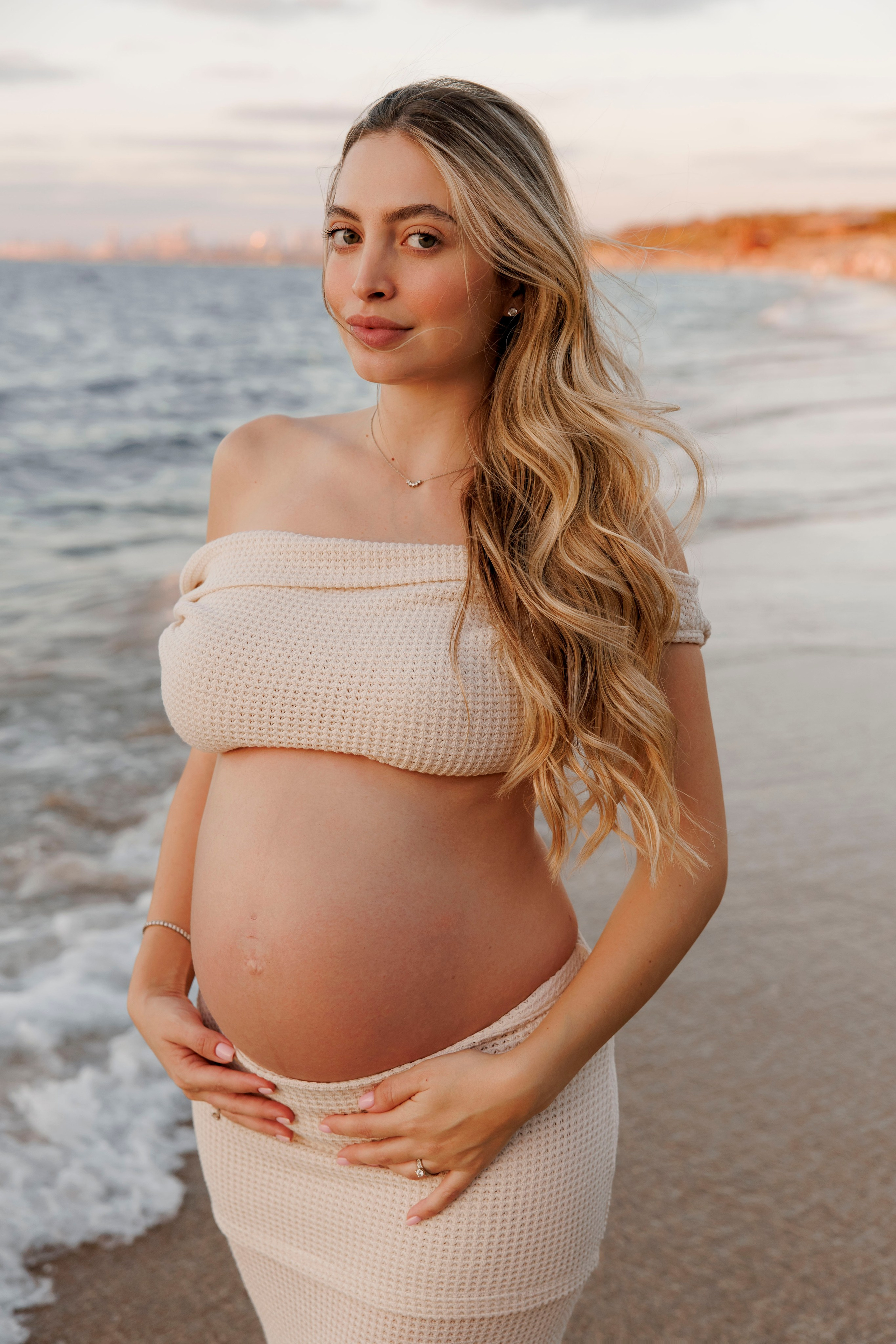Pregnancy photoshoot near the sea. Wedding and family photographer