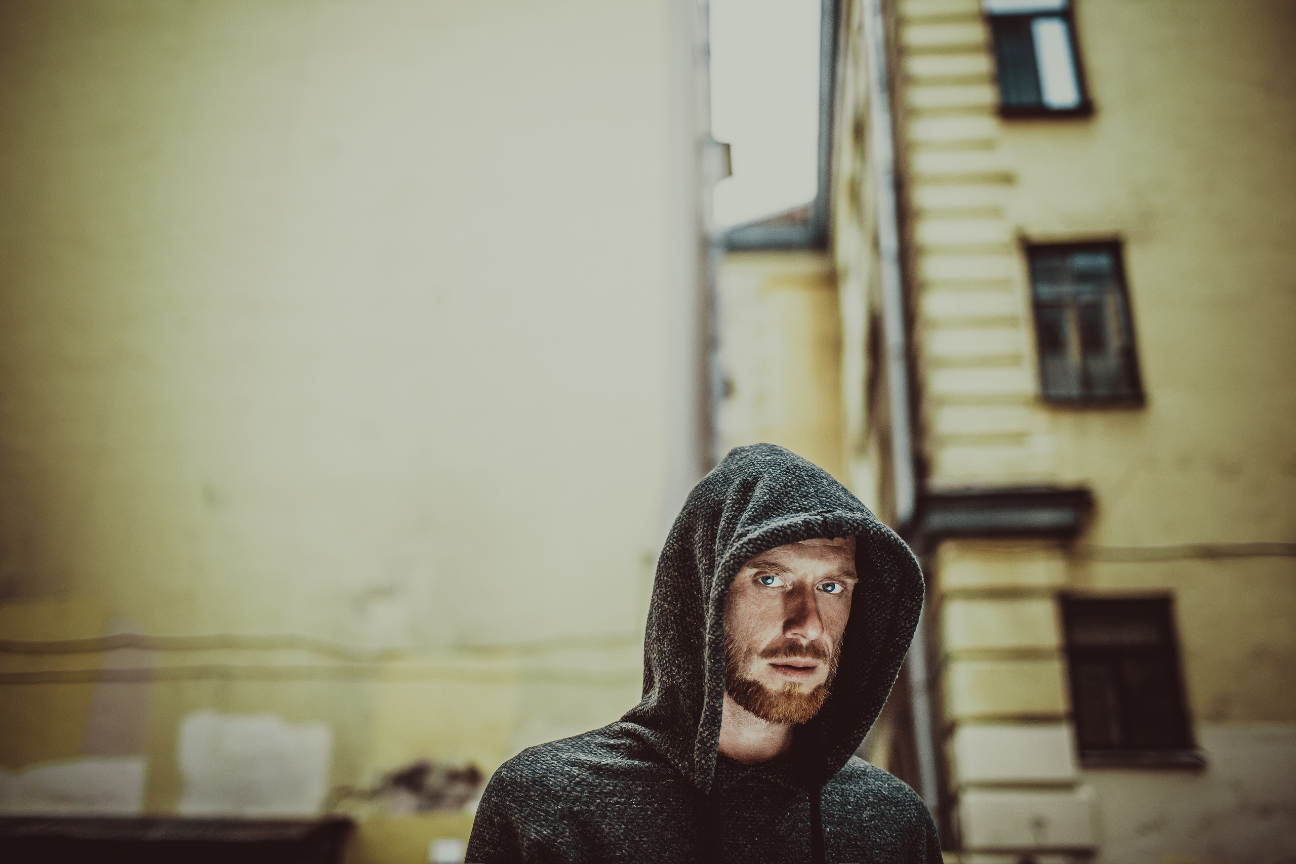 рыжебородый мужчина в капюшоне в Питерском дворе