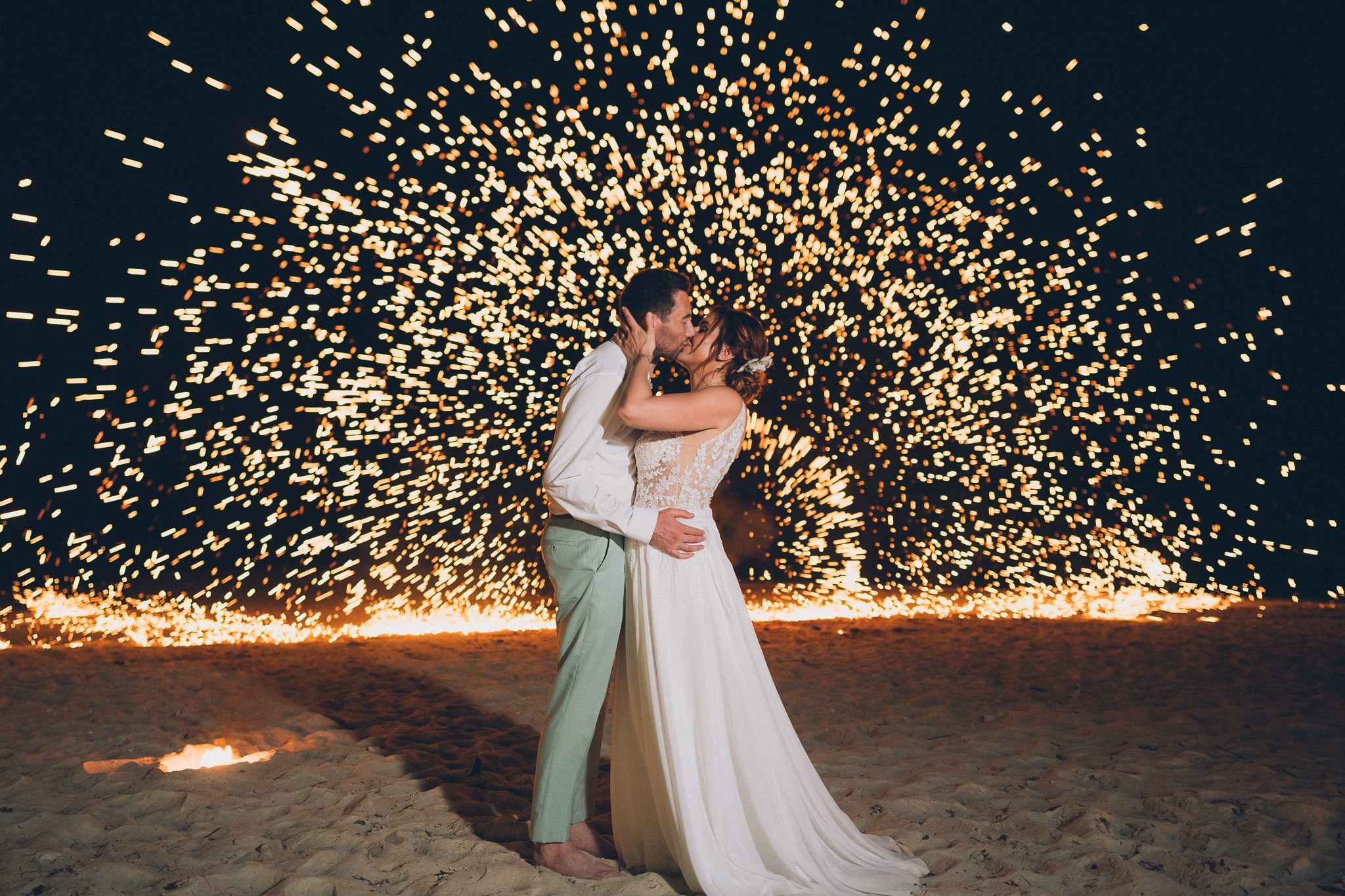 Spectacular fire show performance during a beach wedding reception in Koh Samui