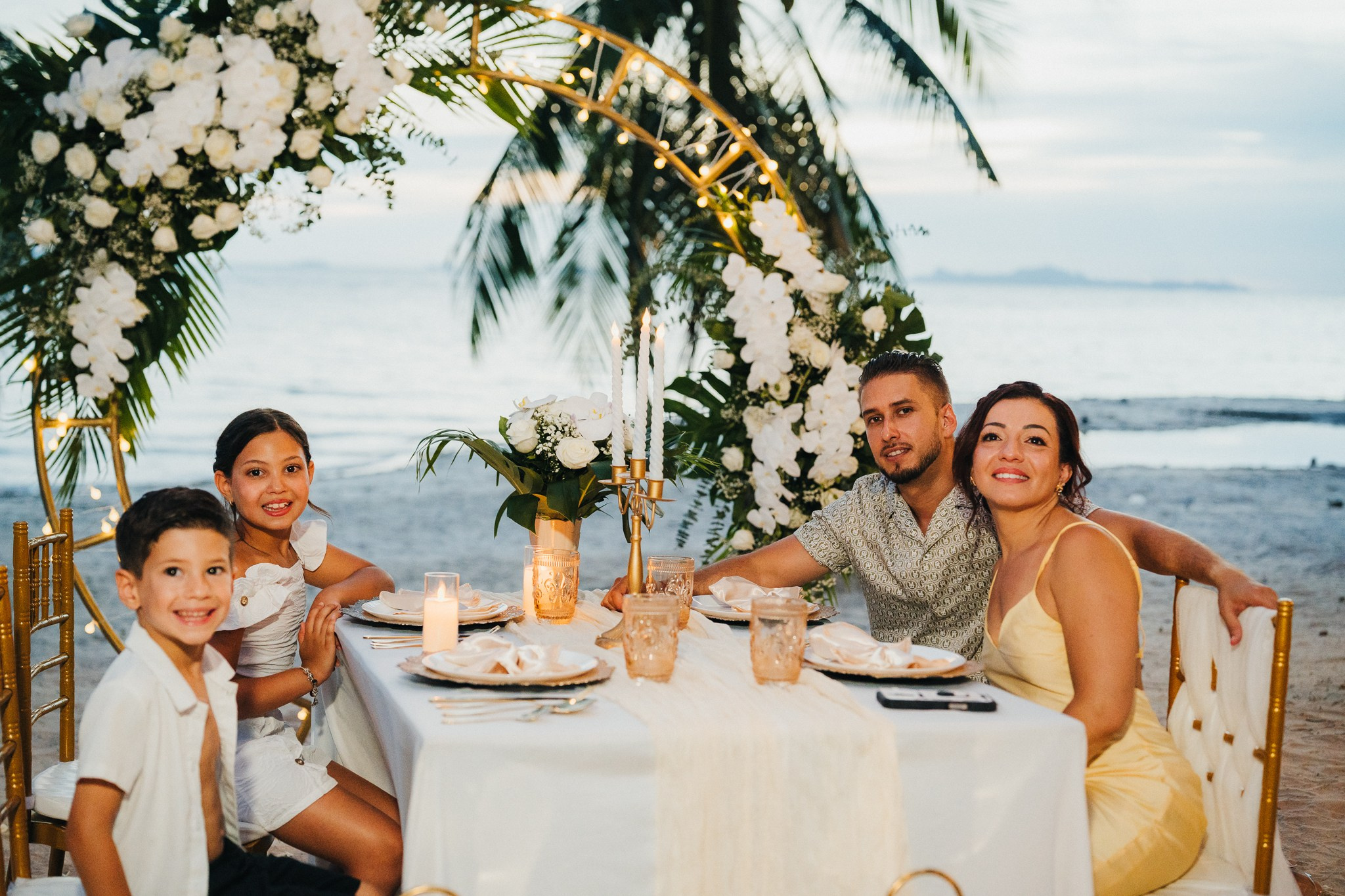 Romantic escape wedding in Koh Samui, Thailand with bride, groom and children on a beautiful tropical beach
