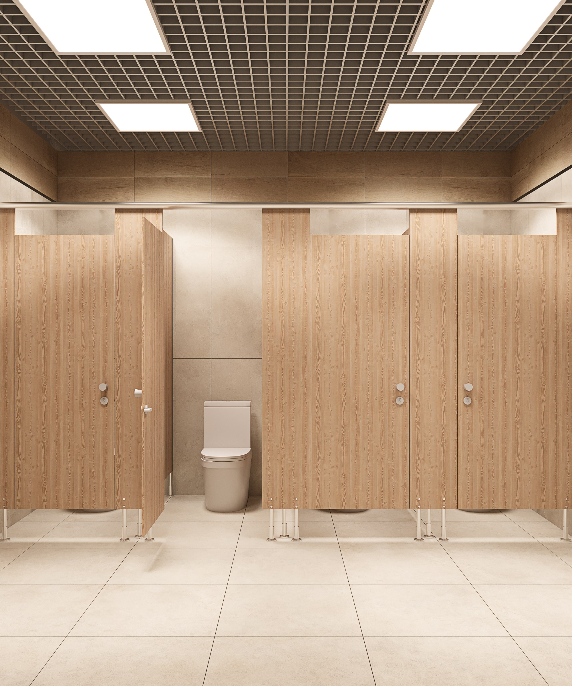 Ряды туалетных кабинок с дверями из светлого дерева; в центре видна открытая кабина с унитазом