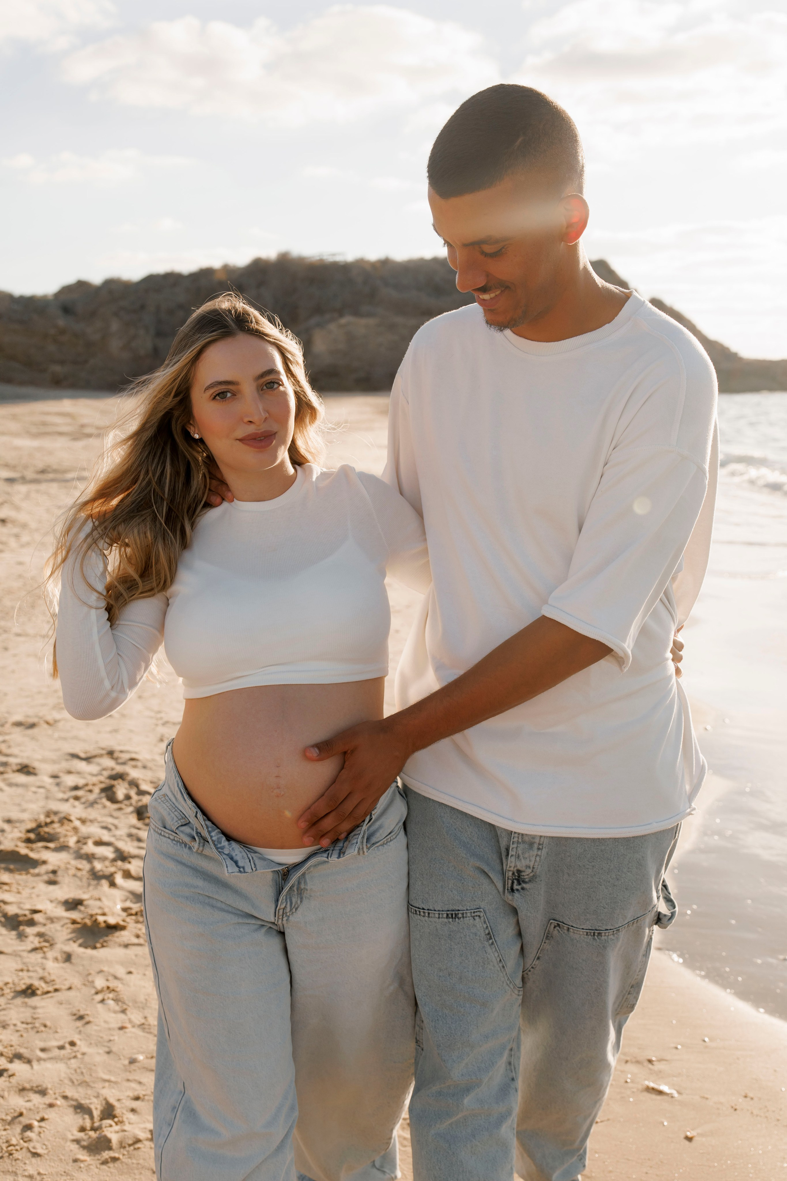 Pregnancy photoshoot near the sea. Wedding and family photographer