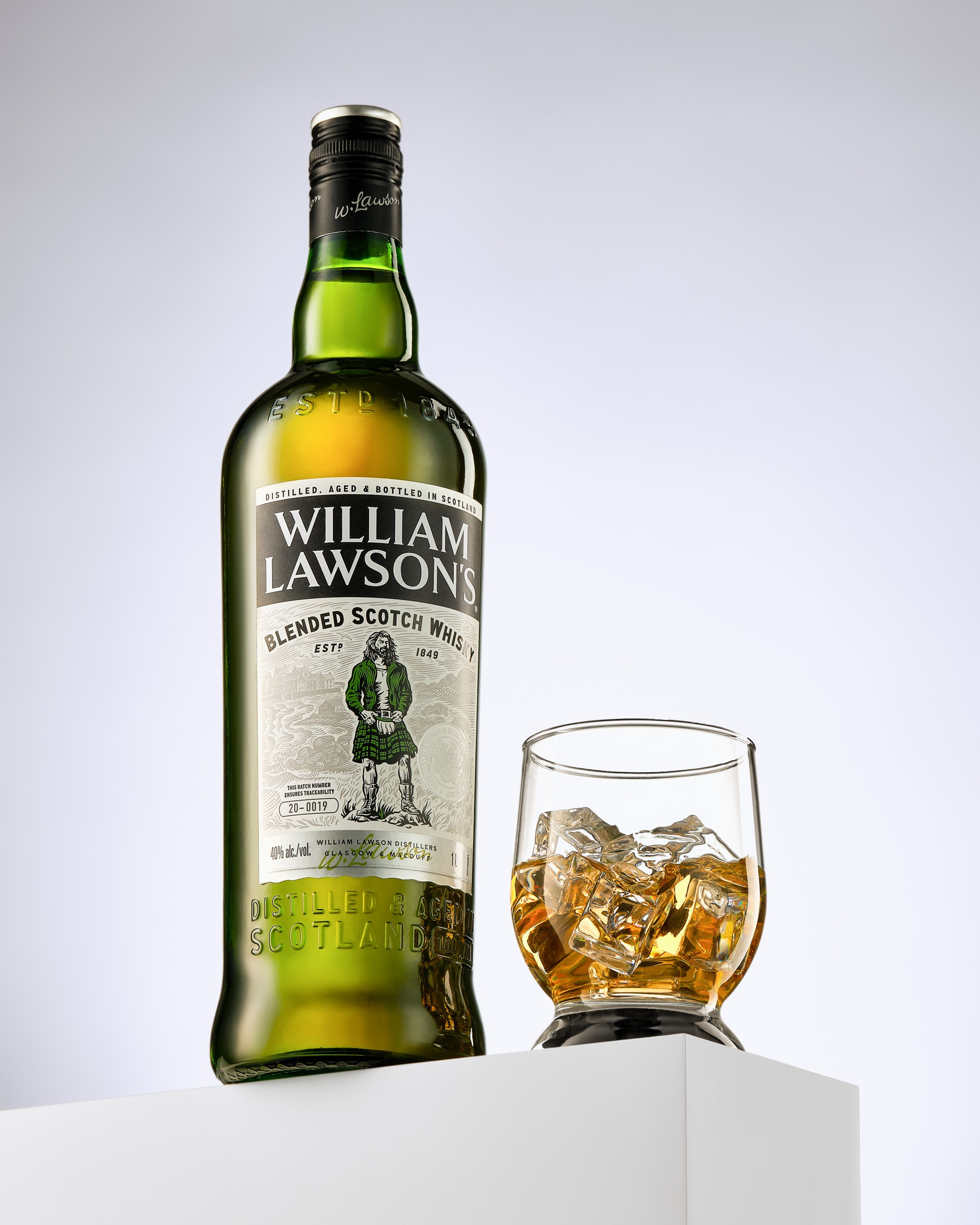 Виски «William Lawson’s» с бокалом на светлом фоне