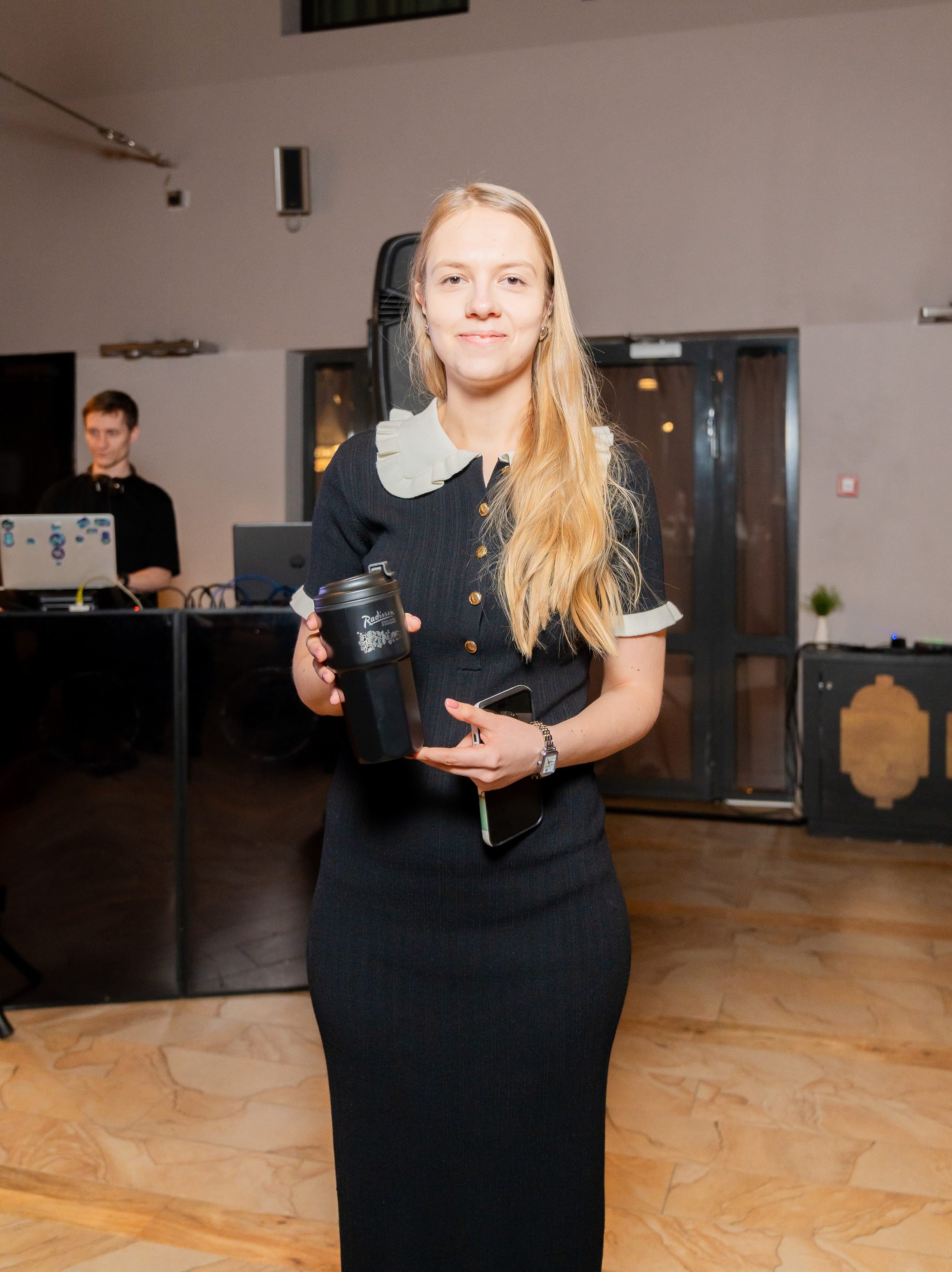 Участница мероприятия в Radisson Sonya позирует с фирменным термостаканом Radisson и телефоном. Фото Евгения Мальцева (evrednix.ru).