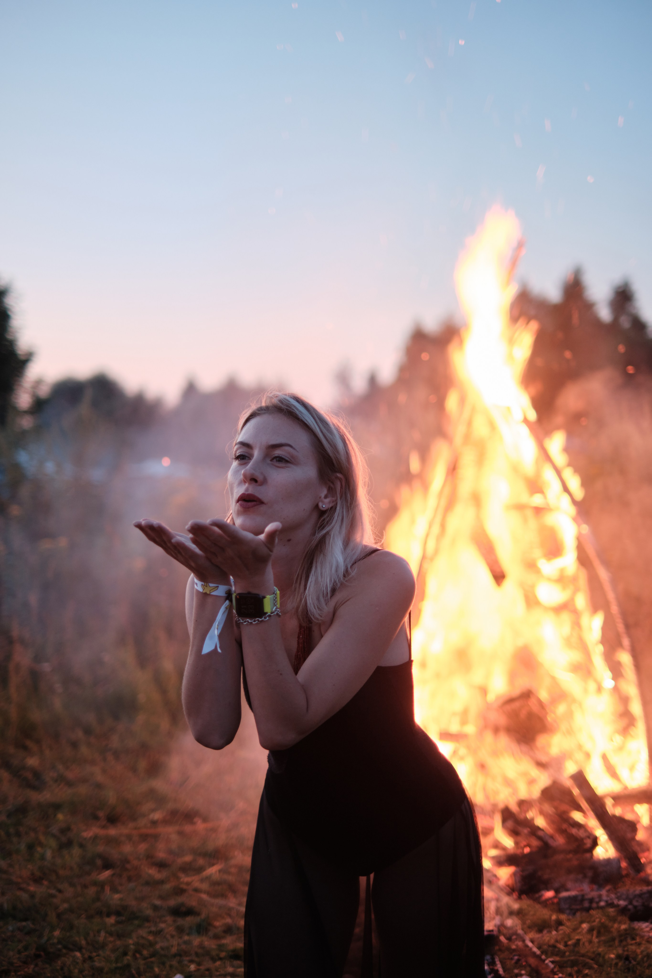 Профиль девушки с закрытыми глазами на фоне яркого огня.