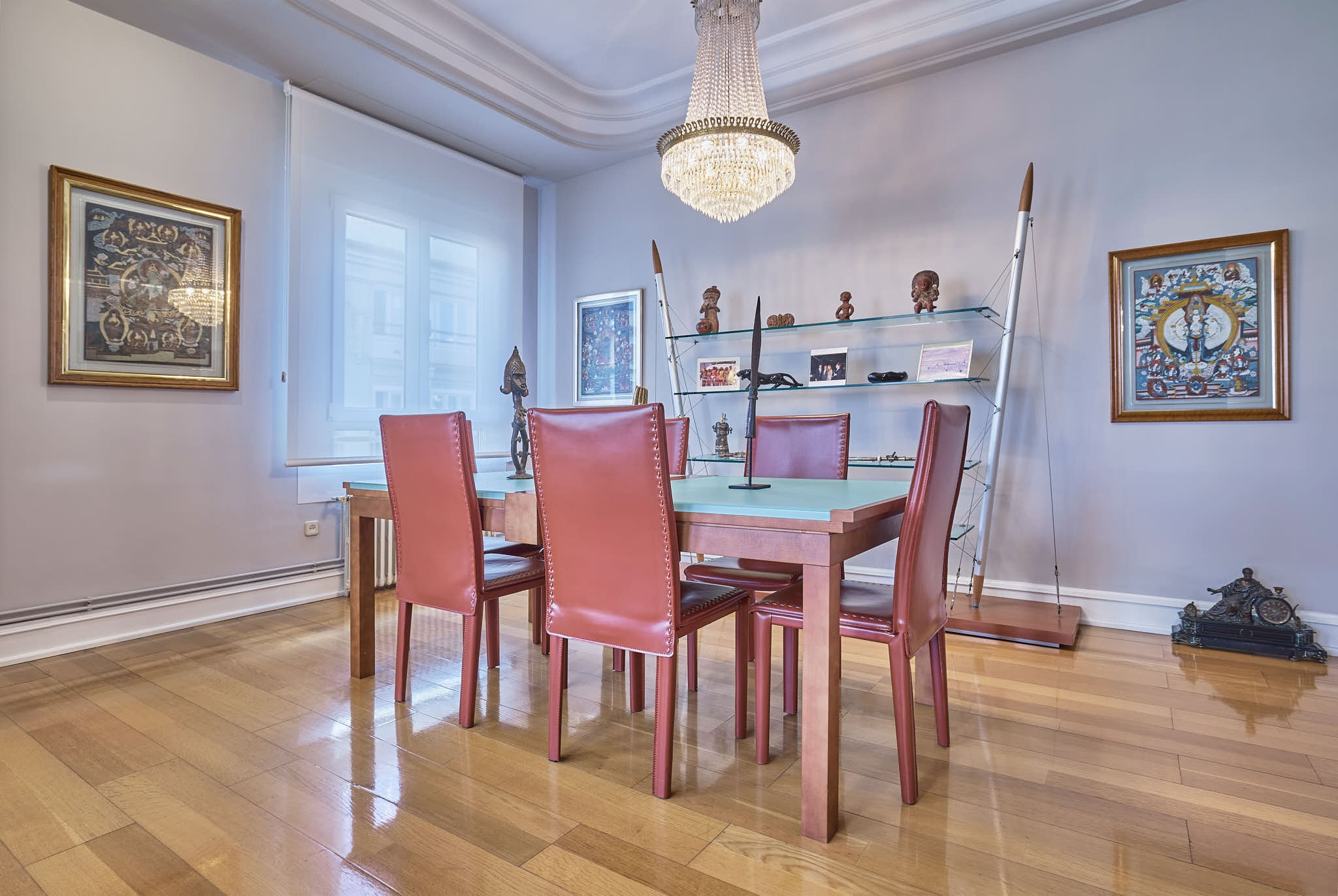 Dining room with table and colorful chairs in an apartment in Valencia