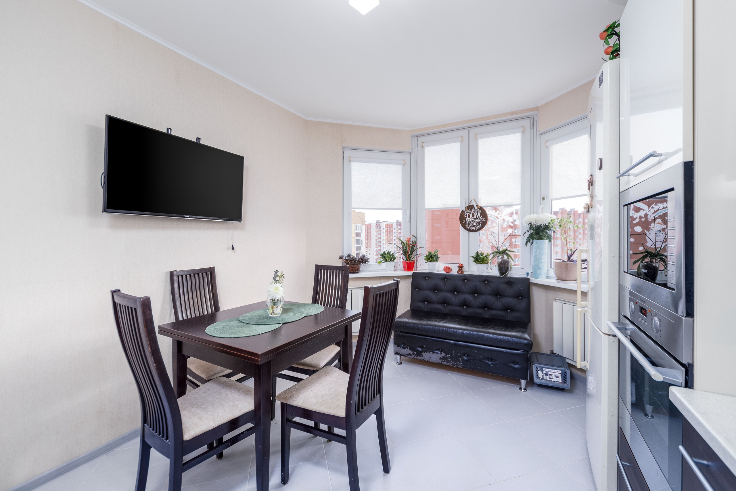 ТВ-зона и зона приема пищи на кухне в двухкомнатной квартире