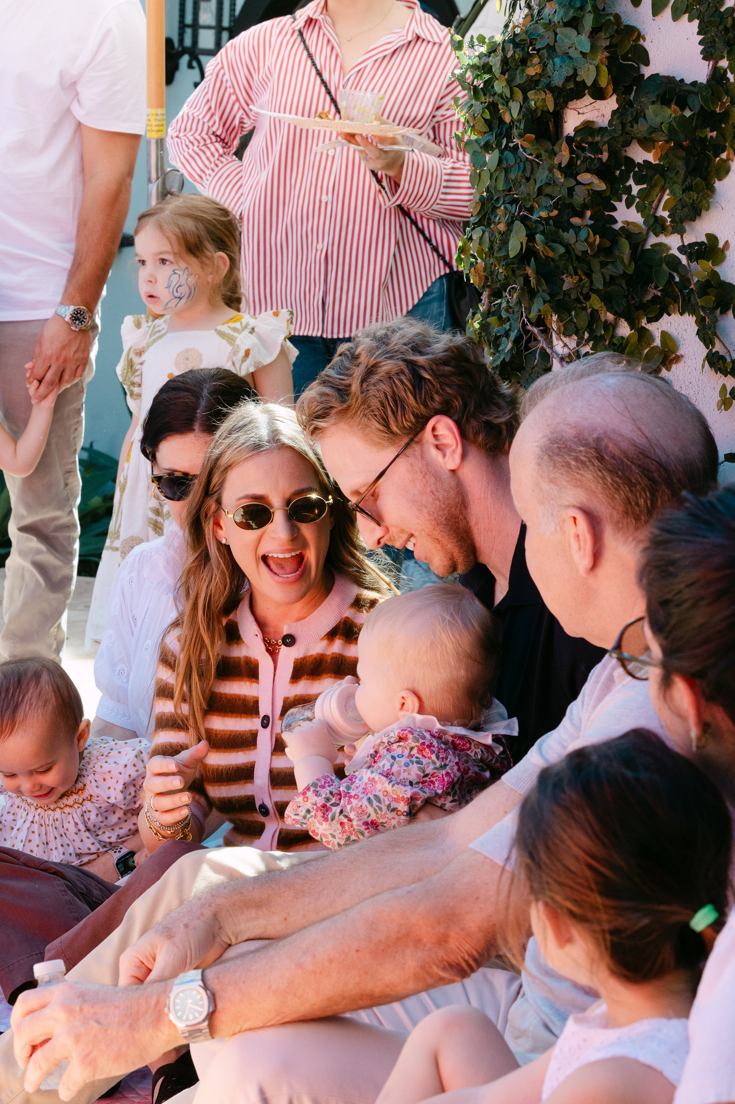 Mom, dad and a girl enjoying puppet performance for her birthday