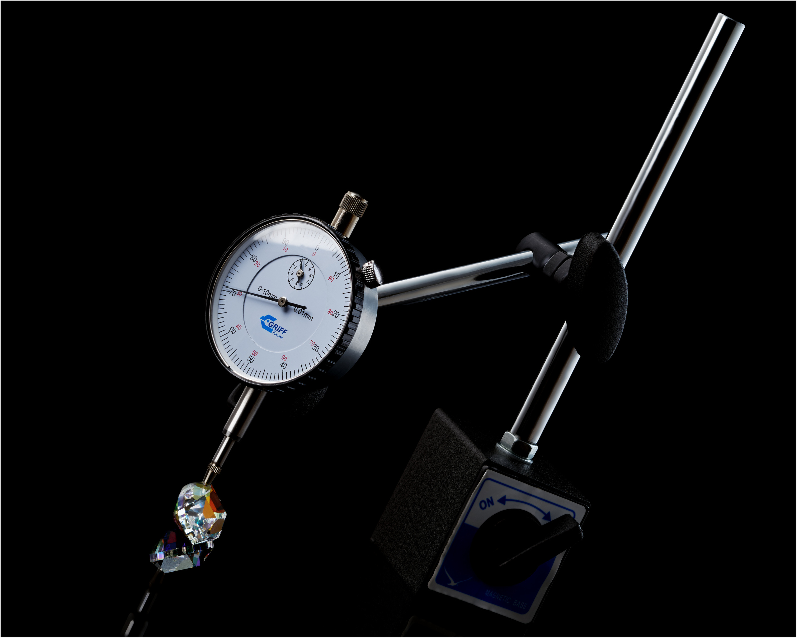 индикаторная головка часового типа на стойке измеряет величину бриллианта