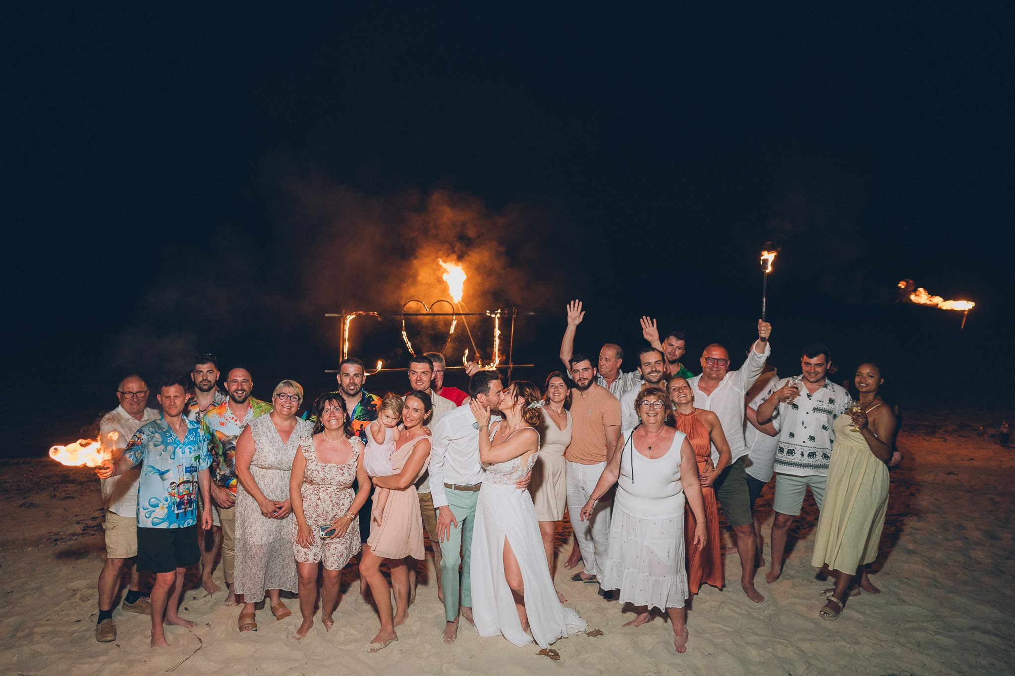 Spectacular fire show performance during a beach wedding reception in Koh Samui