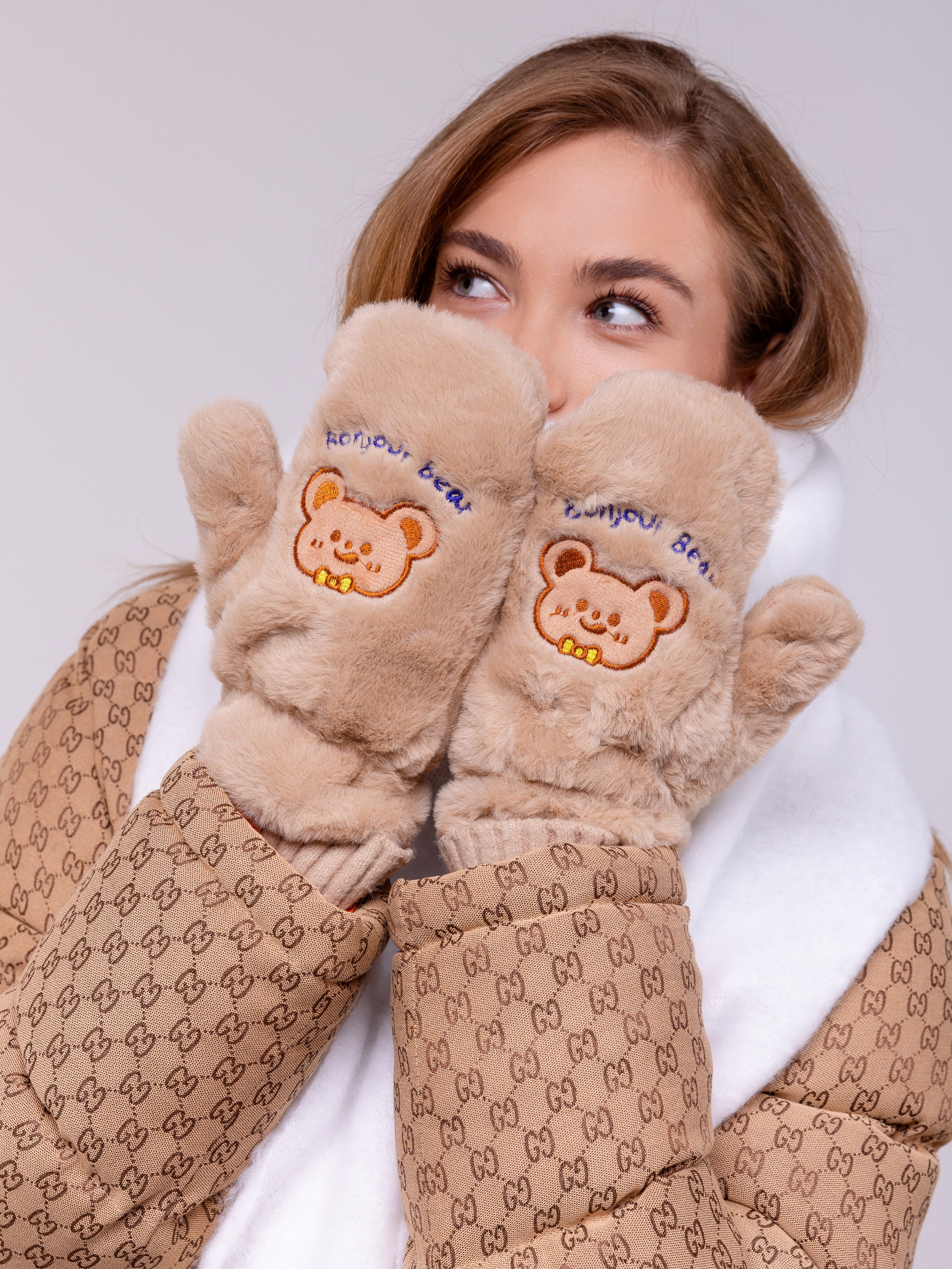 Девушка поднесла к лицу руки в пушистых рукавичках.