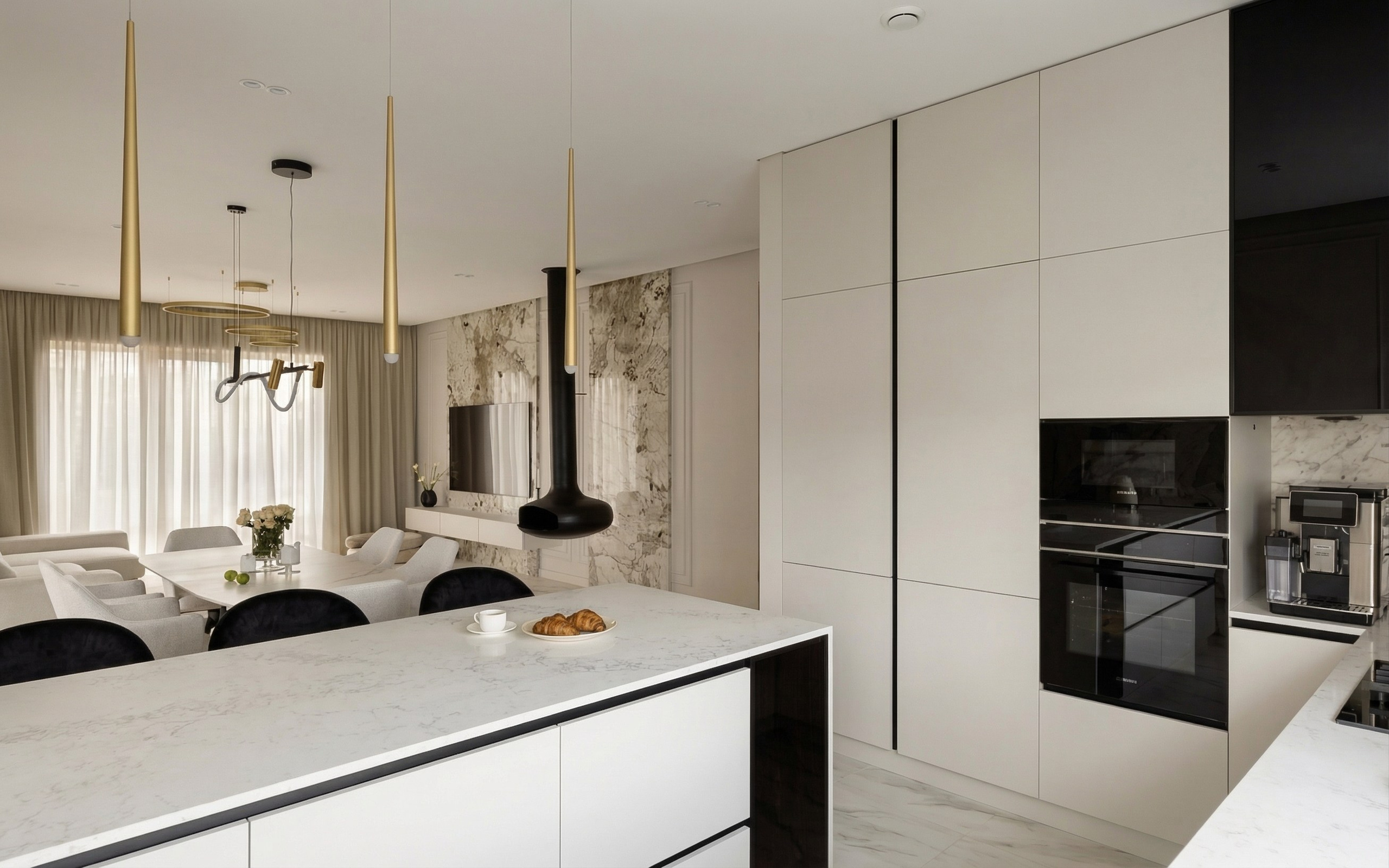 Современная минималистичная кухня с островом в интерьере дома 129 м2 в Краснодаре. Белые матовые фасады со встроенной техникой, каменные столешницы и золотые светильники в проекте дизайнера Валерии Котович.