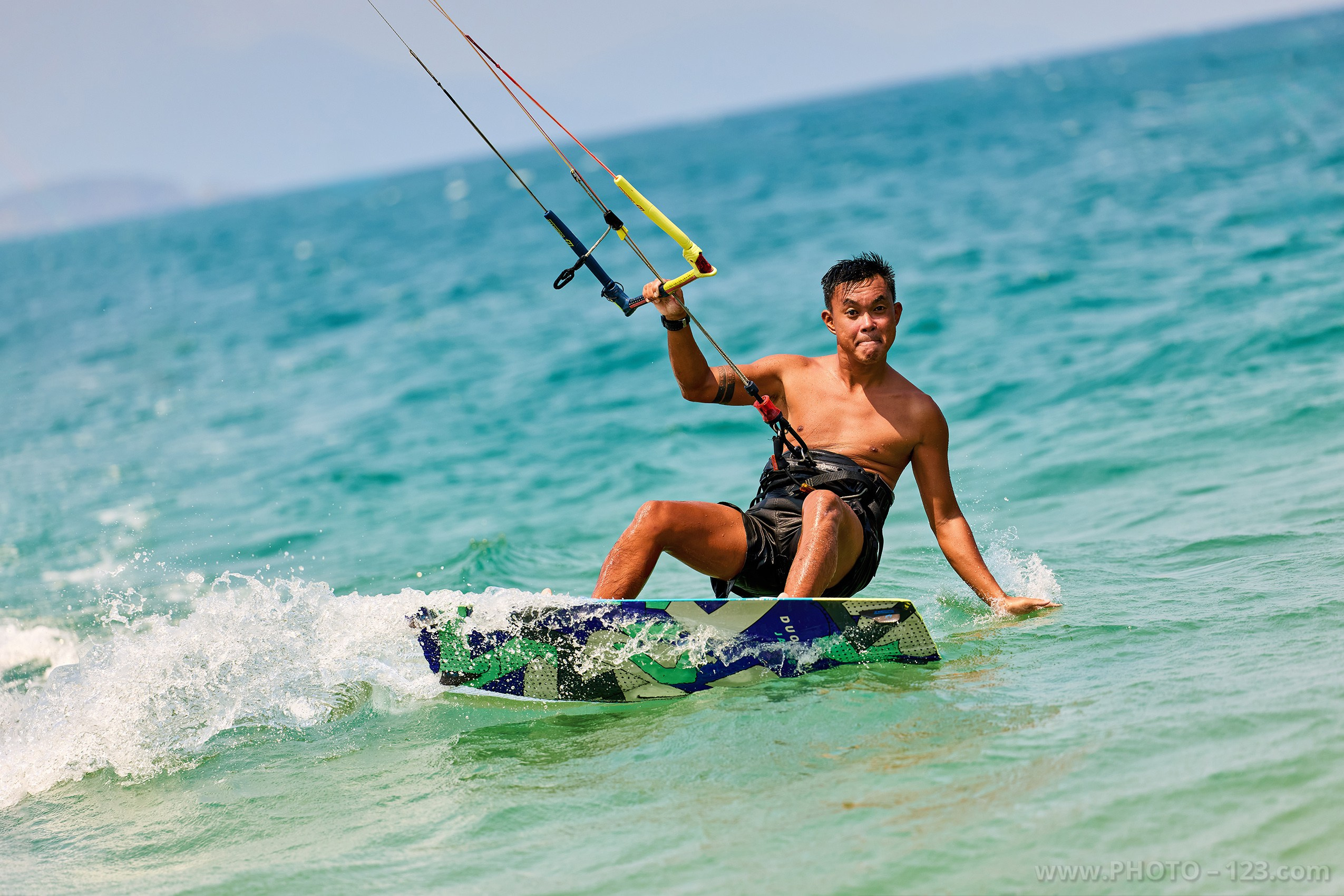 Dynamic kitesurfing action shot in the turquoise waters of Nha Trang, Vietnam | Captured on Canon EOS R5 by Professional Nha Trang Photographer.
