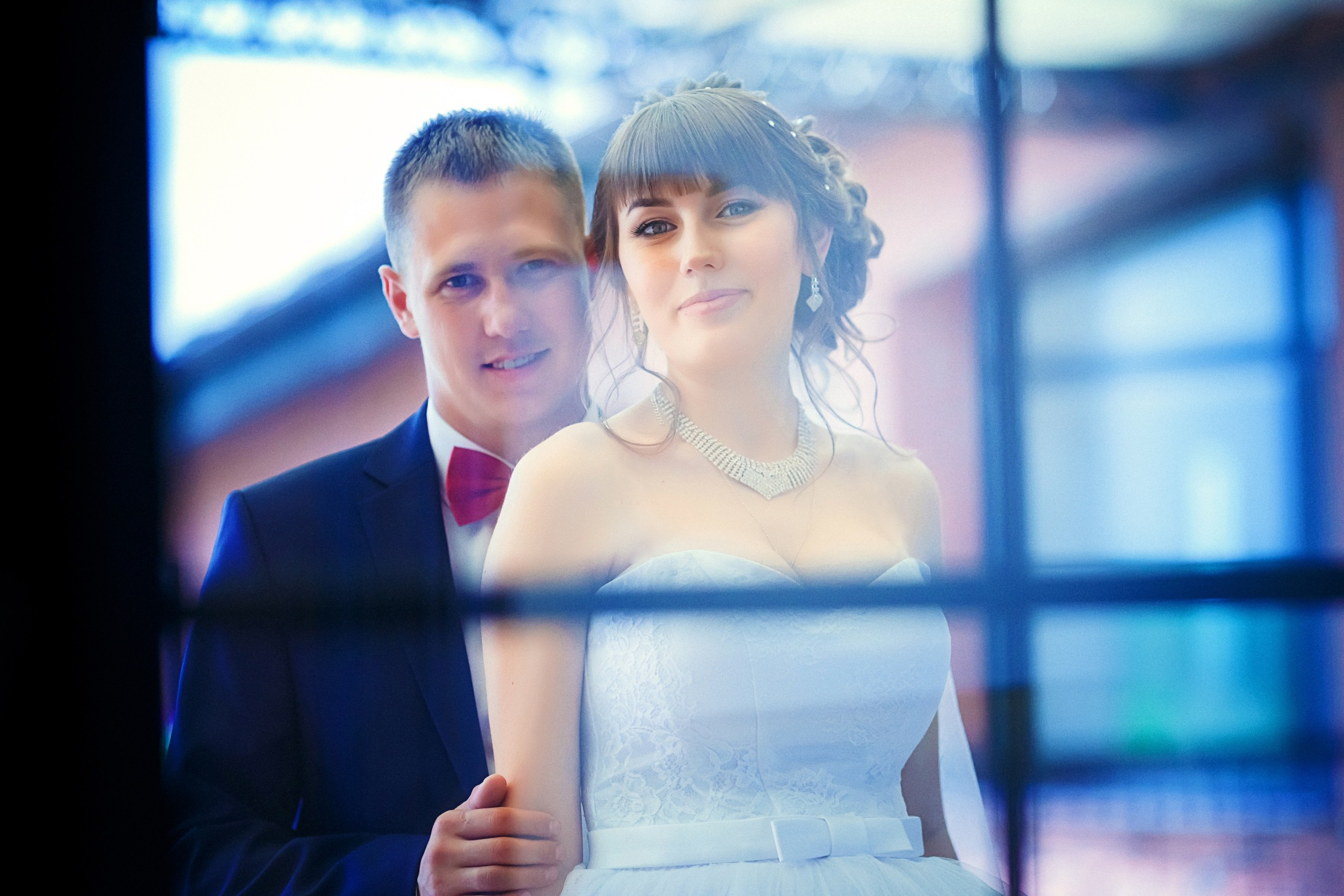 Свадебная съемка. Фотография жениха и невесты через стекло