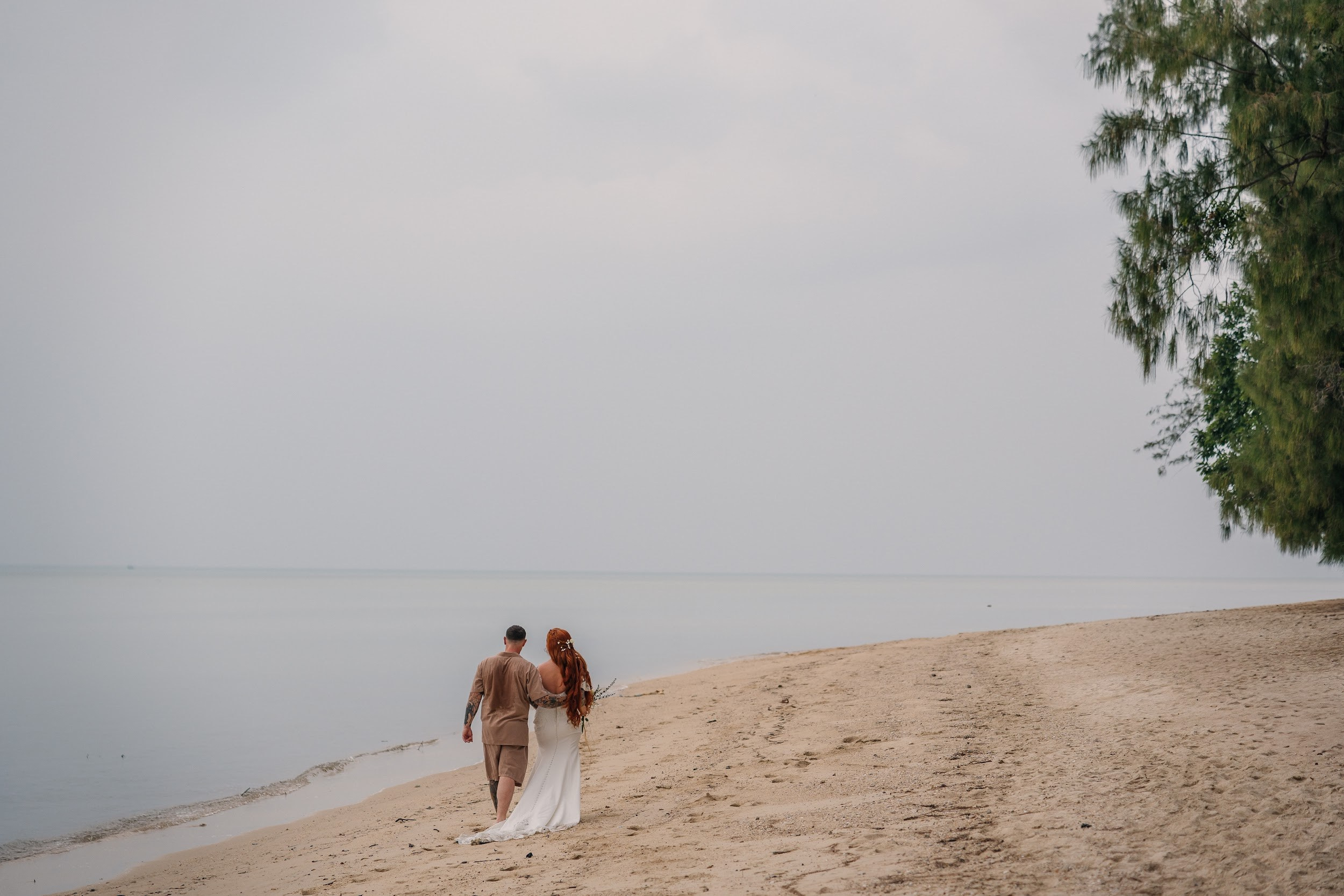 Bride and groom during a romantic beach wedding ceremony on Koh Samui, Thailand, surrounded by tropical scenery and ocean views
