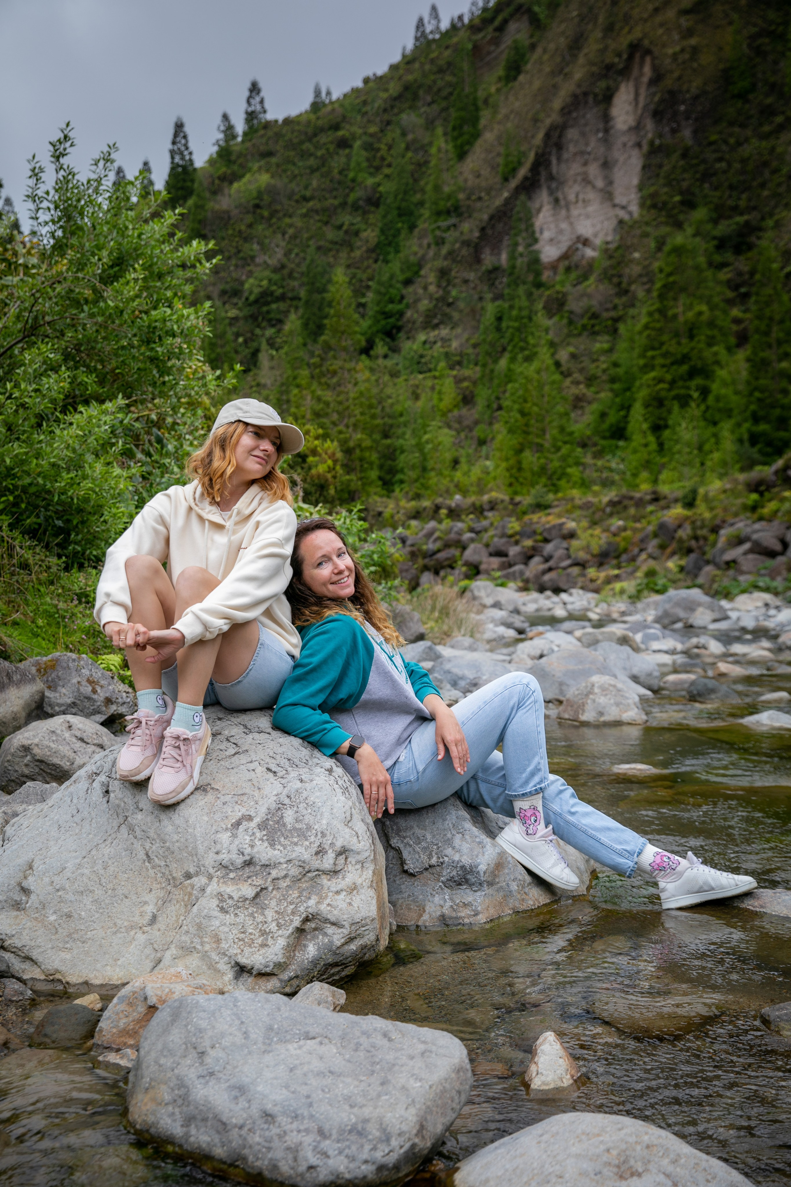 Women enjoying a peaceful stroll in the Azores, surrounded by vibrant greenery, the ocean, and an endless sky