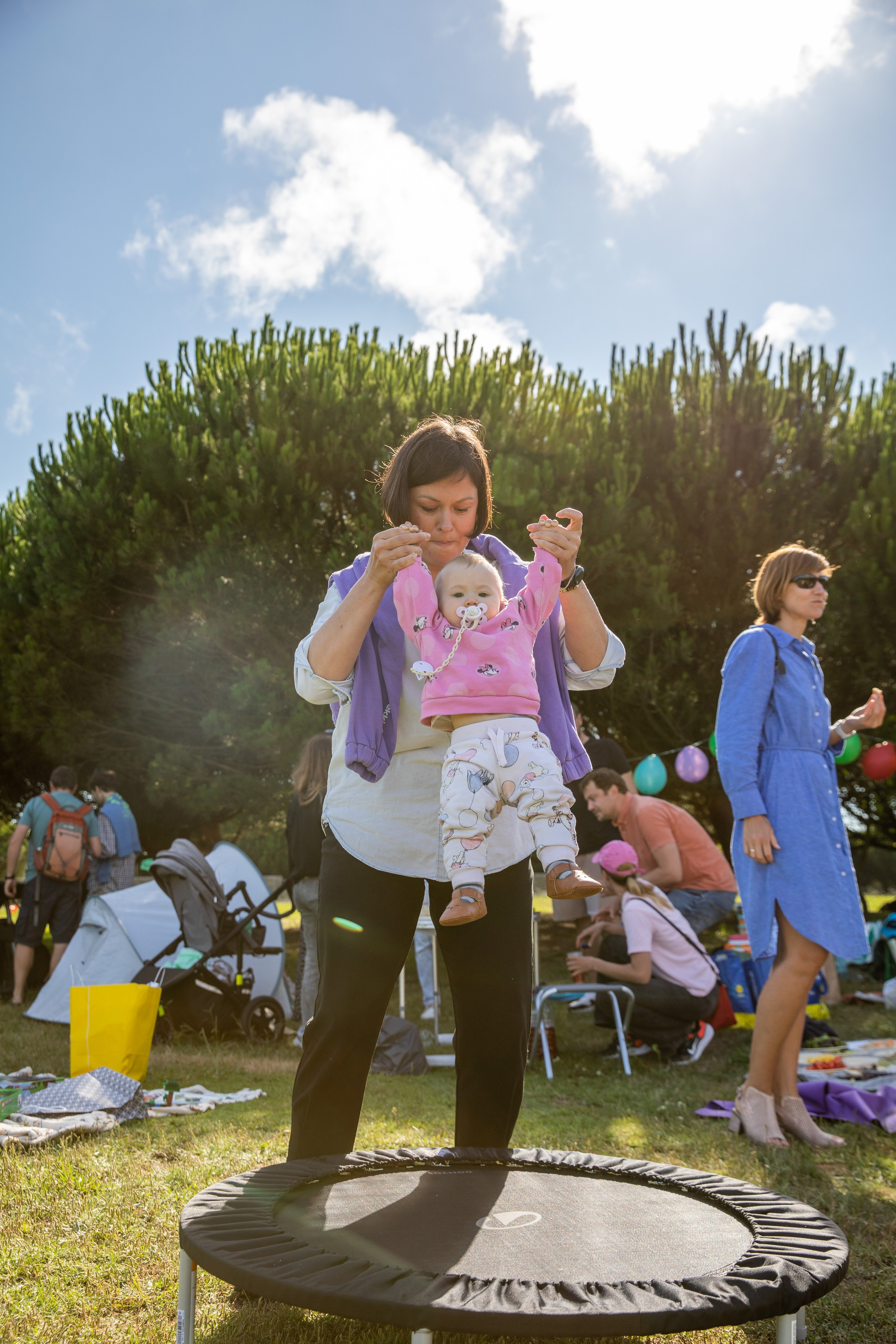 Park birthday photo shoot with kids having fun and soap bubbles in the air