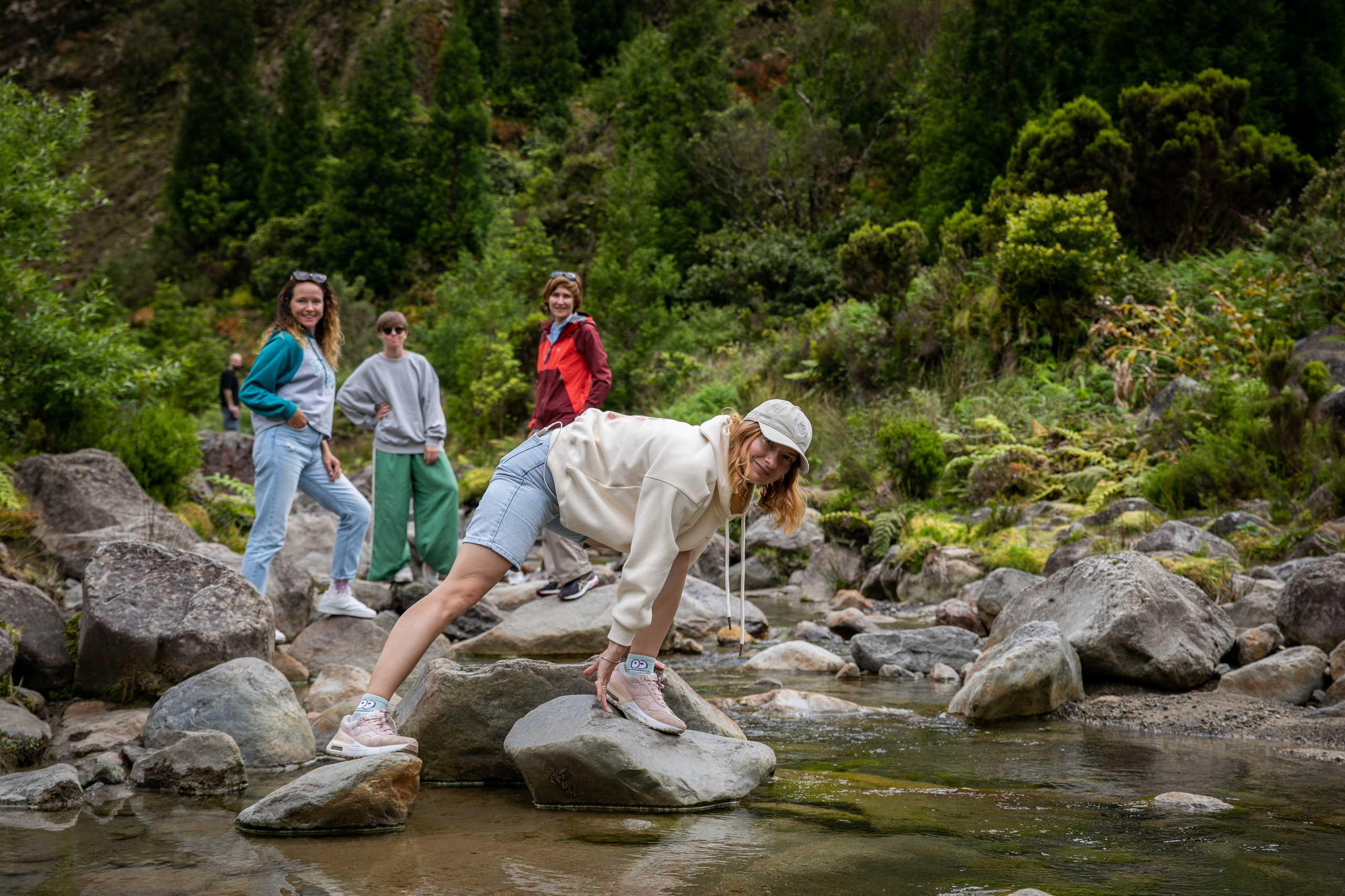 Women enjoying a peaceful stroll in the Azores, surrounded by vibrant greenery, the ocean, and an endless sky