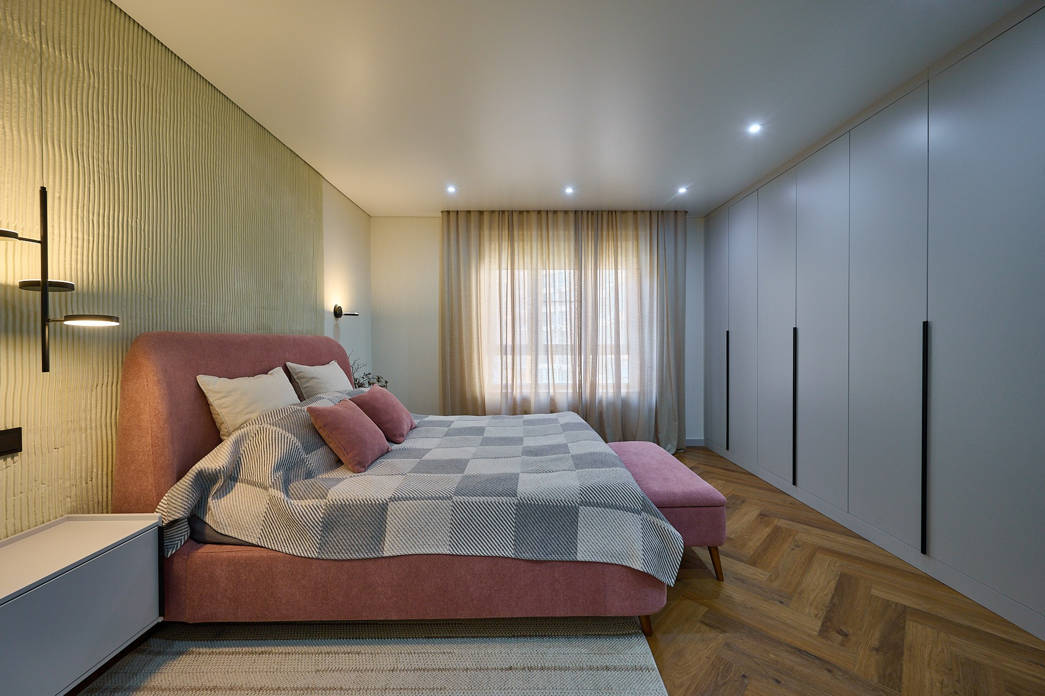 комната розовая кровать светлые обои белые шкафы розовая тумбочка кресло плетенное 