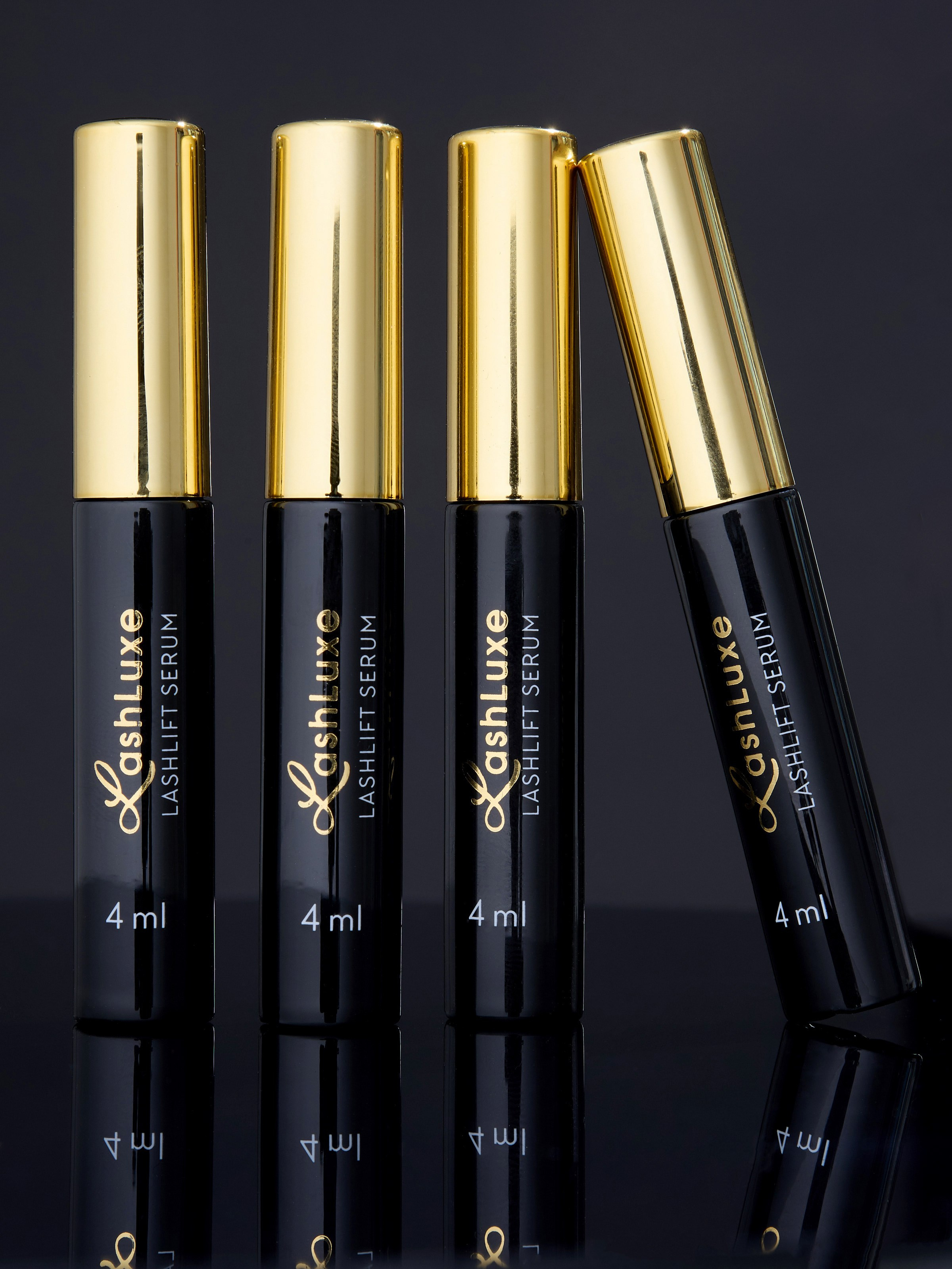 Композиция из четырех тюбиков с каплями для ресниц | Фото на черном фоне для Ozon