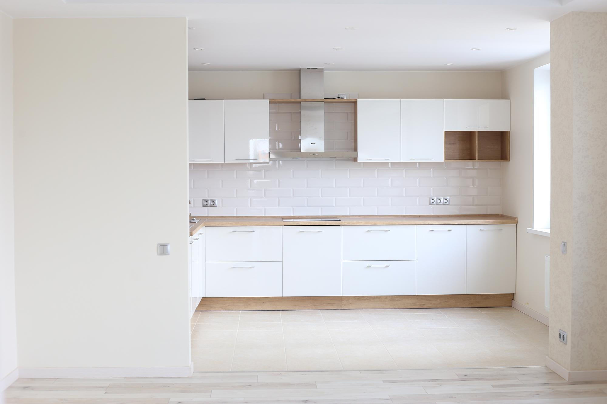 вид из белой гостиной на просторную светлую кухню