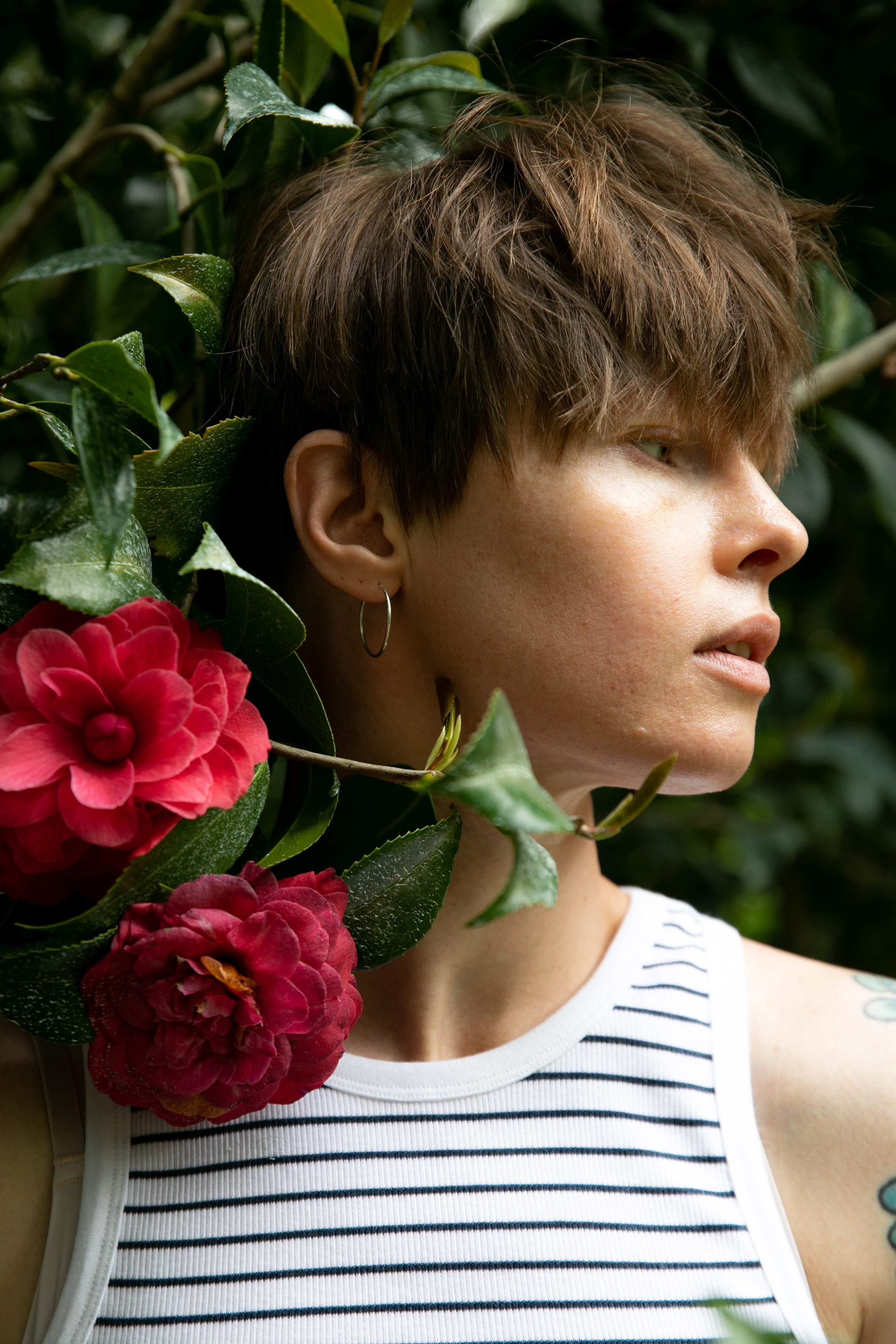 A serene moment of a woman surrounded by colourful flowers on the Azores